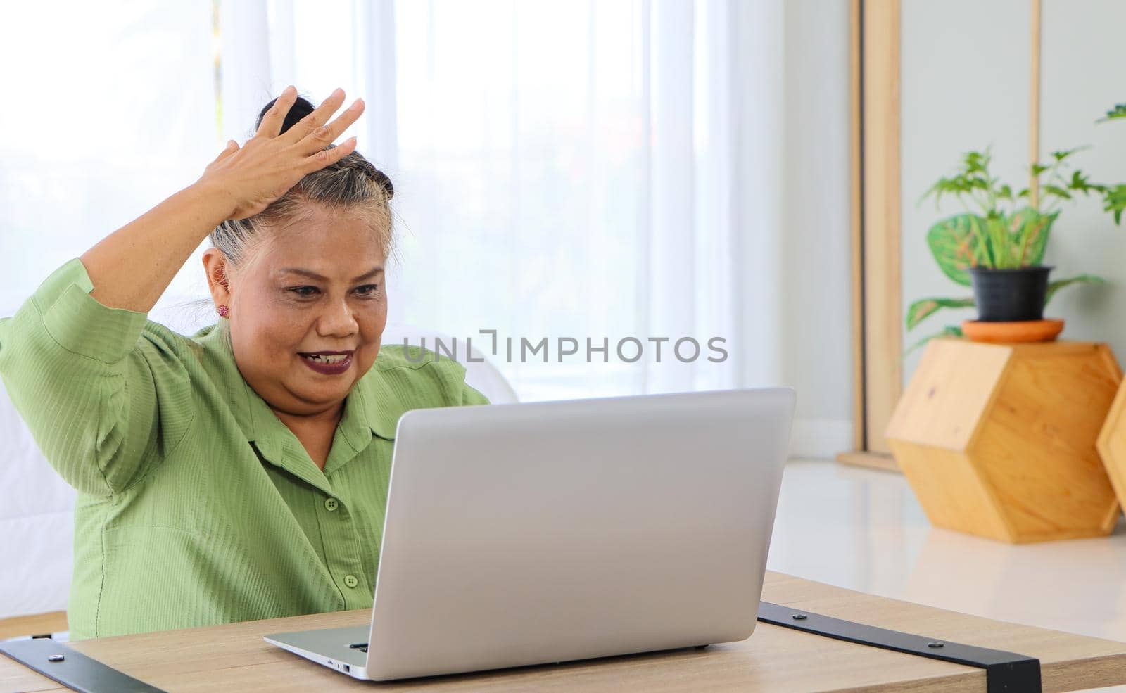 Senior Asian women Raise your glee while chatting via video call Concept Get good news online Get better insurance, pension service offer. Or talk to a family far away from each other in the room