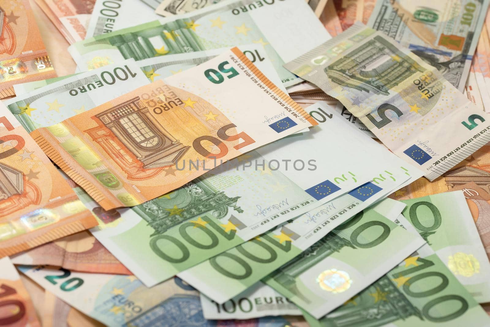 Background of dollar, euro banknotes on a table by Estival