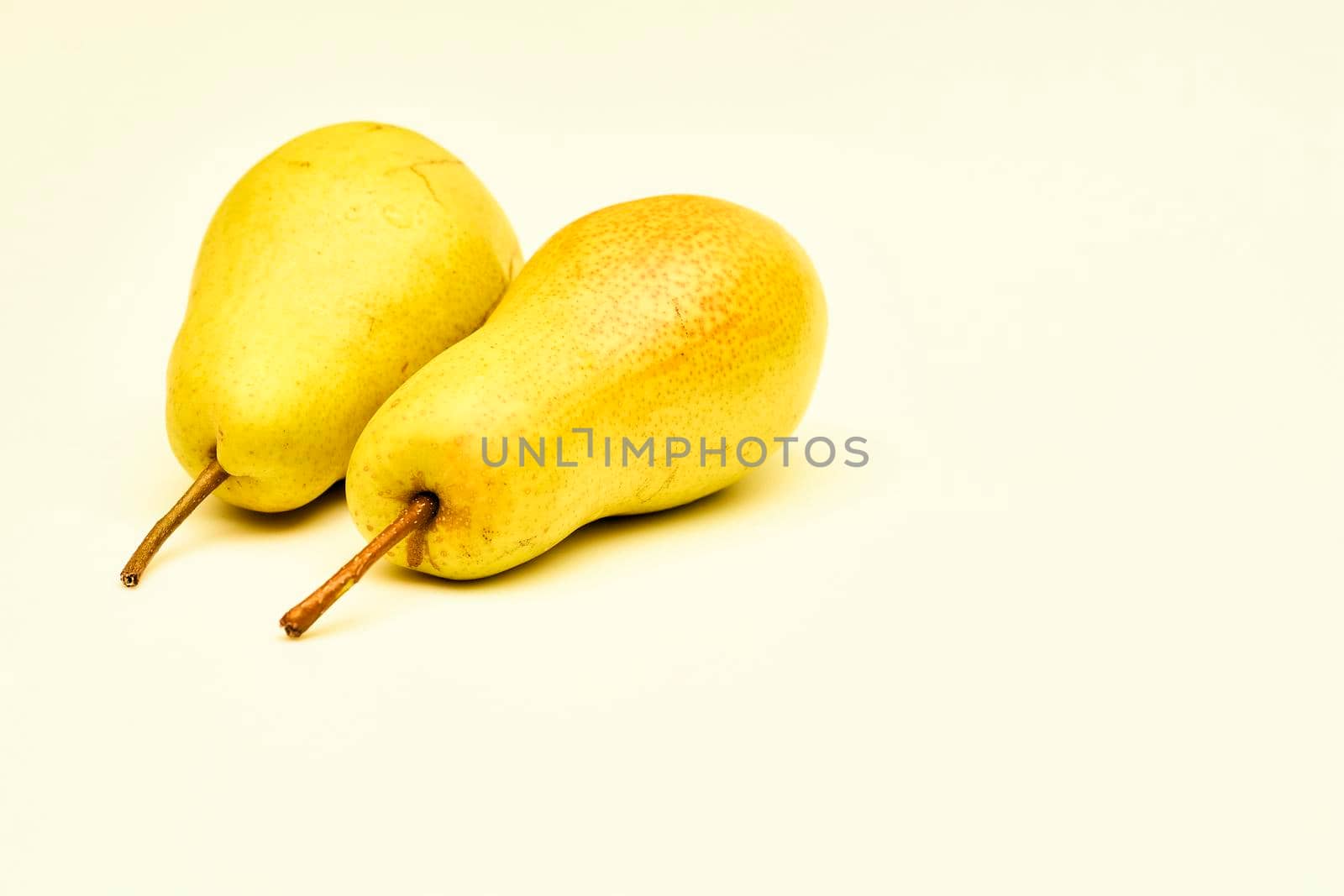 Two yellow ripe pears on an isolated white background by jovani68