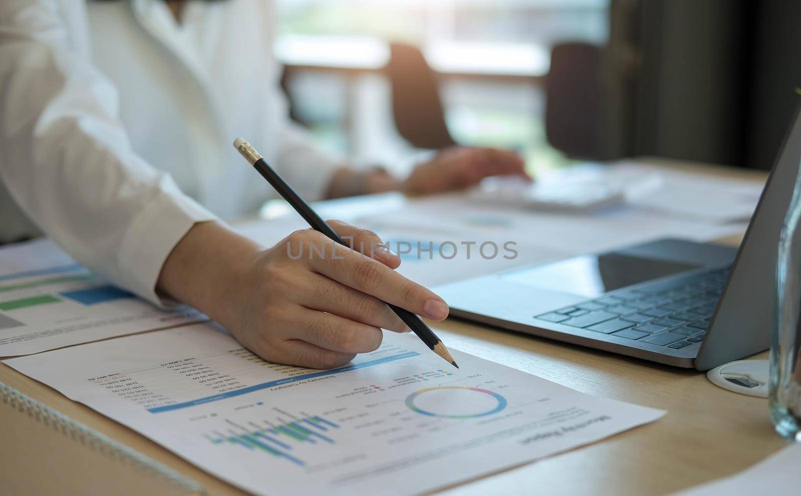 Close up Businesswoman using calculator and laptop for calaulating finance, tax, accounting, statistics and analytic research concept.