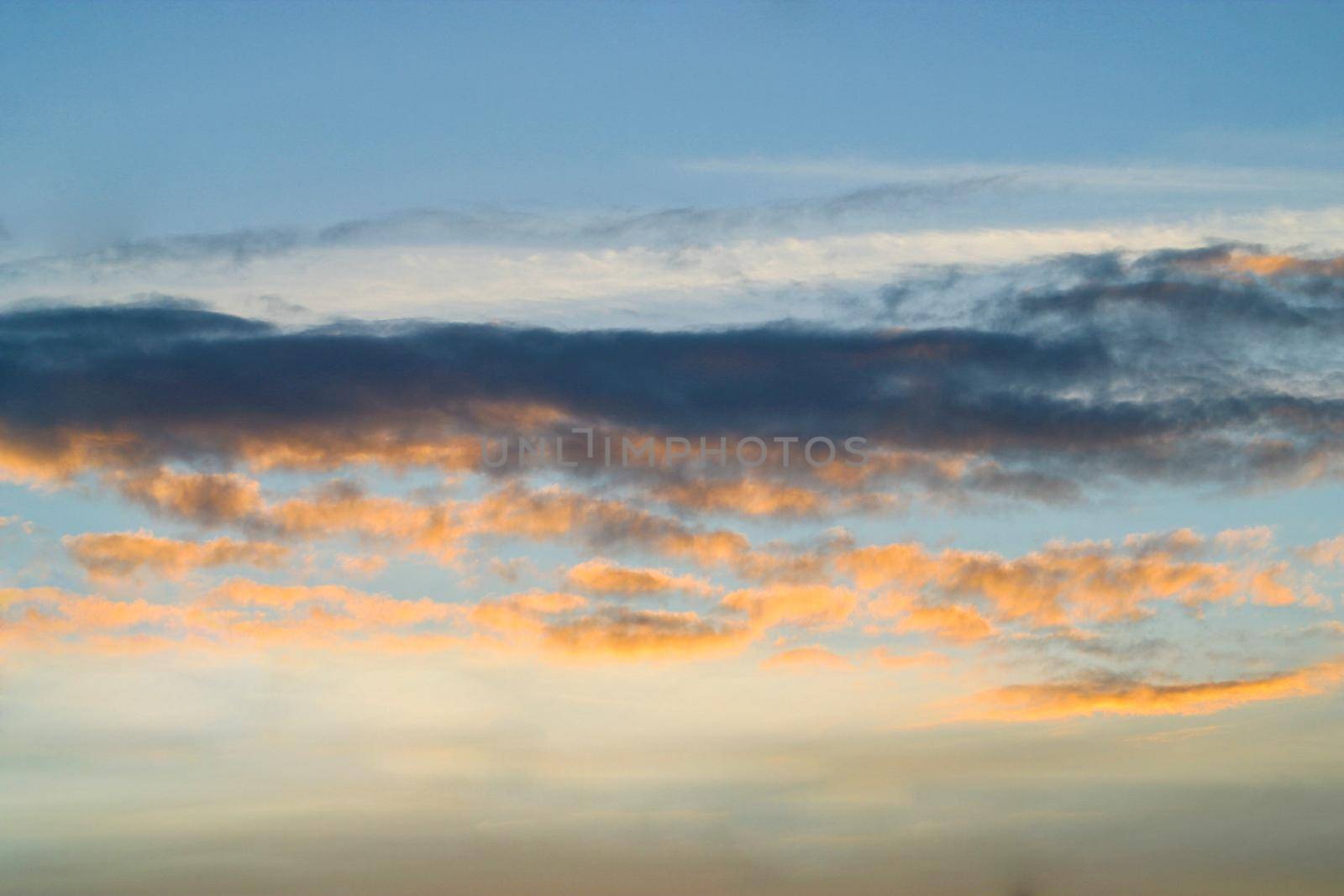 Clouds in a sky during colorful sunset. Sky in evening
