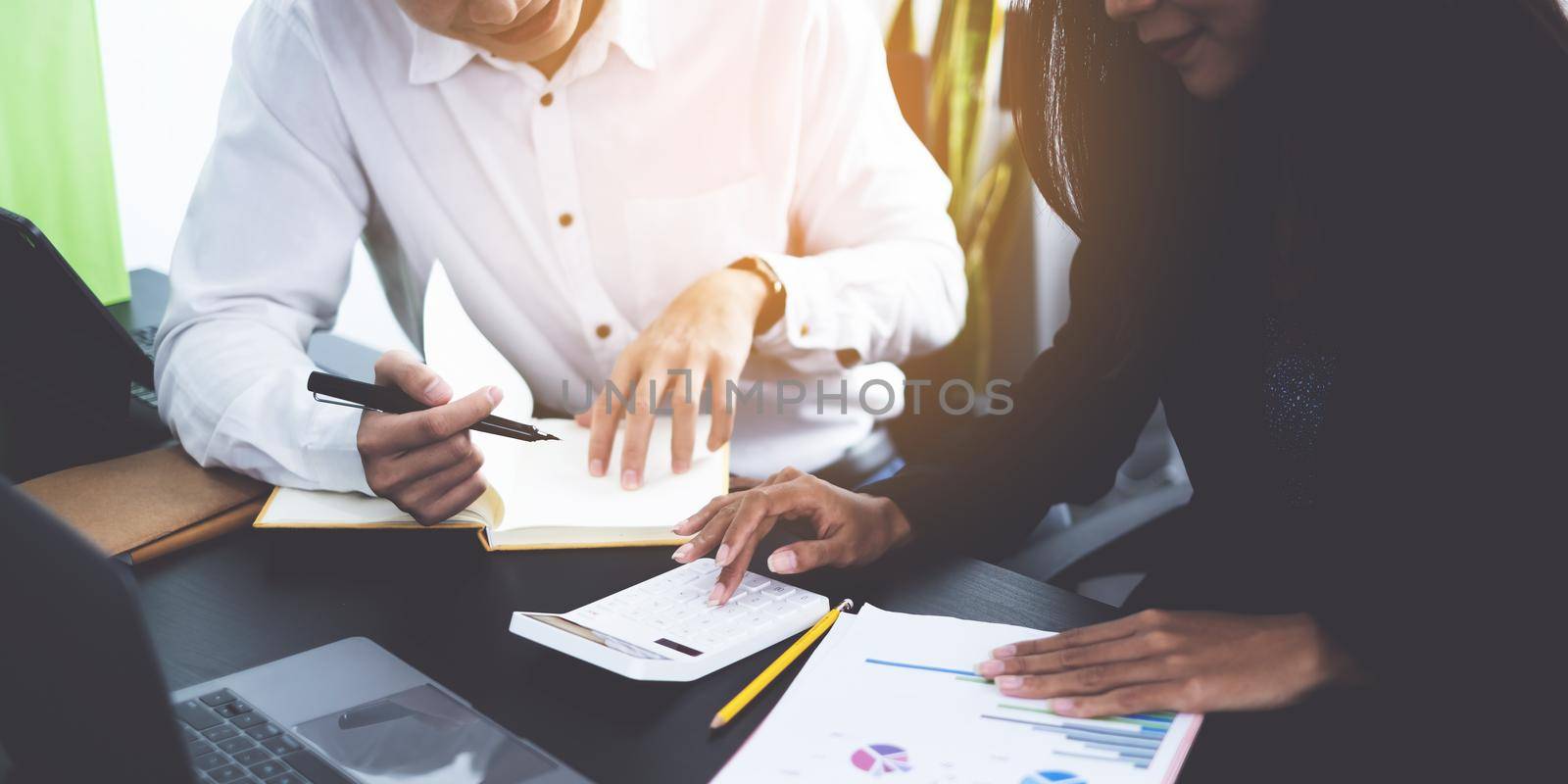 For the investigation of a corruption account, a group of businesswomen and accountants search data documents on a laptop. definition of anti-bribery. by itchaznong