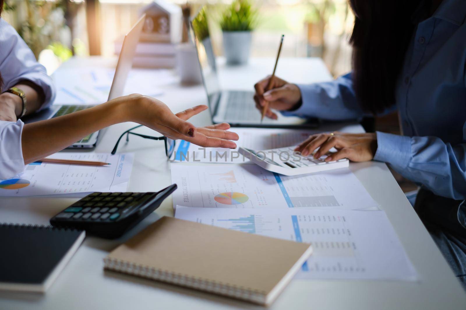 For the investigation of a corruption account, a group of businesswomen and accountants search data documents on a laptop. definition of anti-bribery