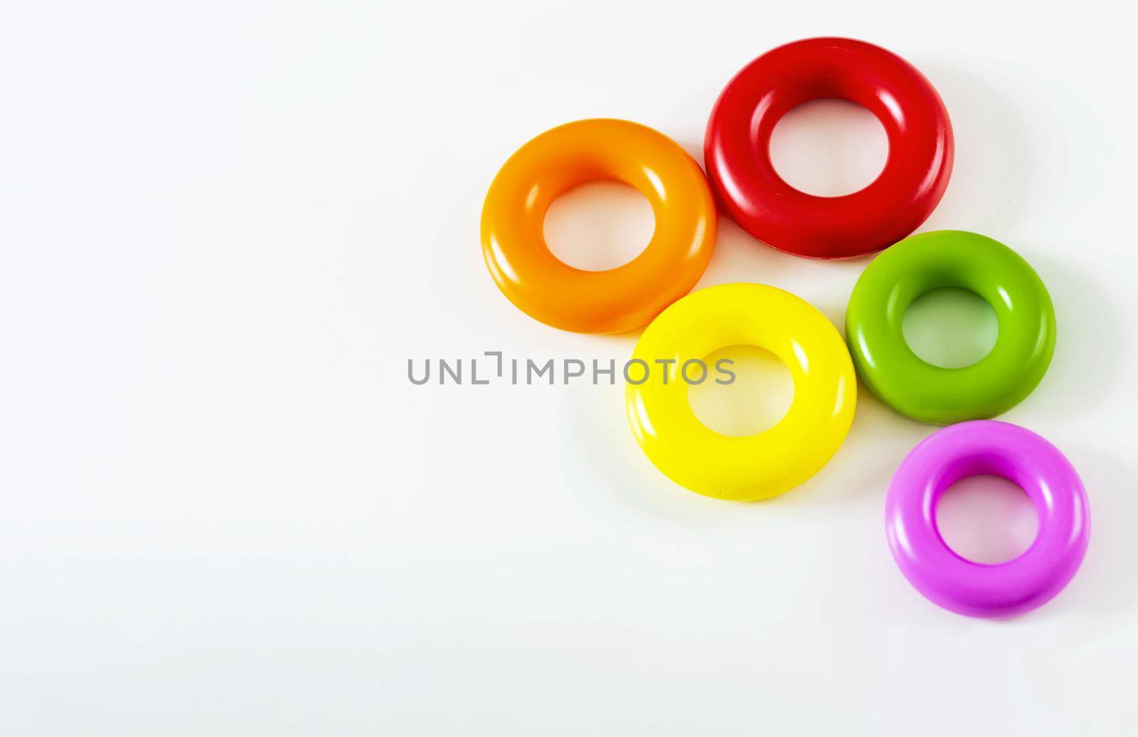 a group of of five colorful plastic rings isolated on a white background. Children's toys. Same size for each ring