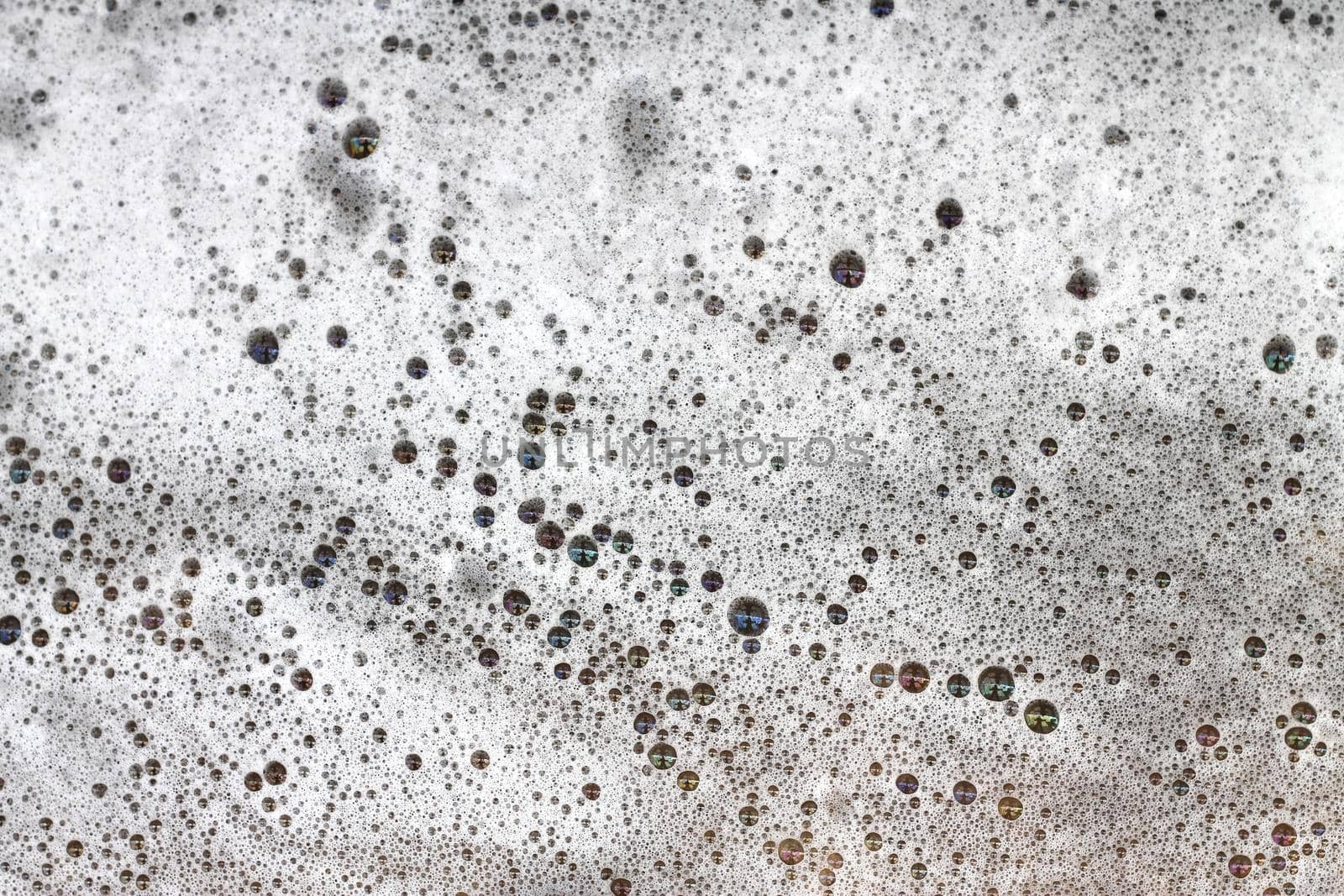 Detergent bubbles float in the waste water. by pichai25