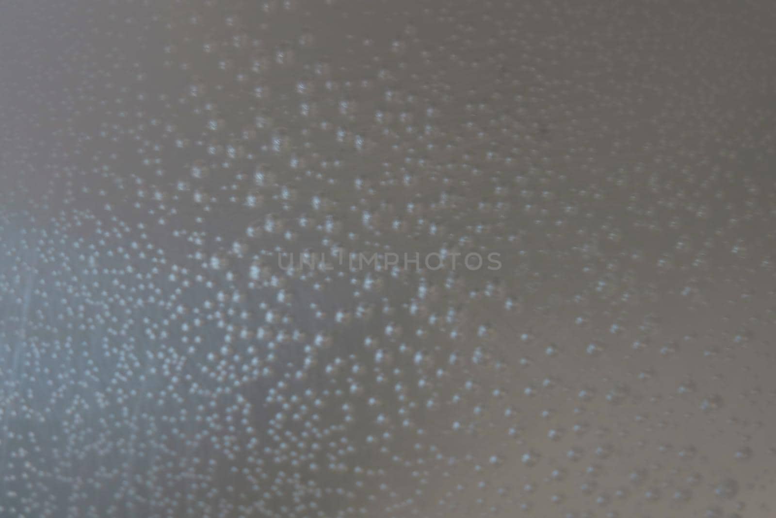 Out of focus. Blurred background. Bubbles on the sides of the cookware when the water is heating