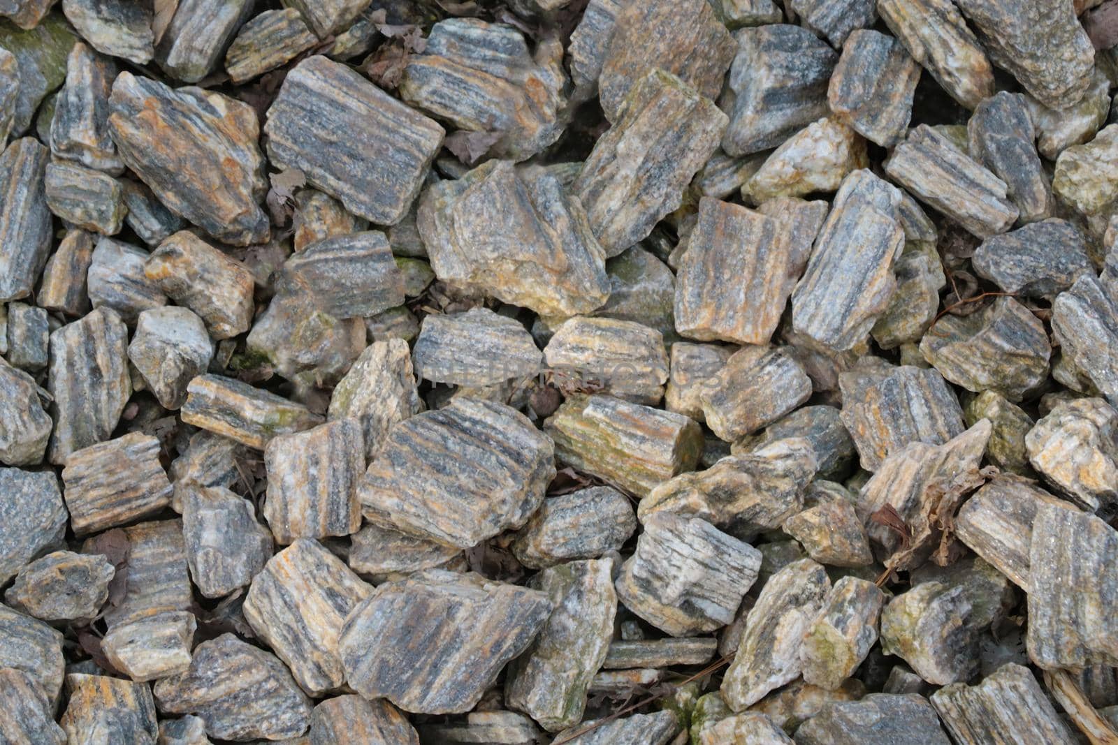 Top view of small pieces of rock on the ground. Background, texture of stone