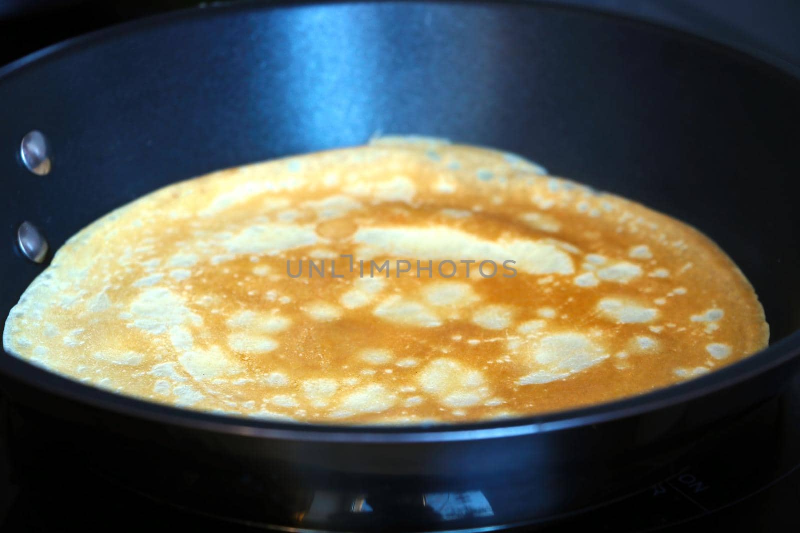 Prepare a pancake in a skillet. Light and pleasant breakfast. Homemade food