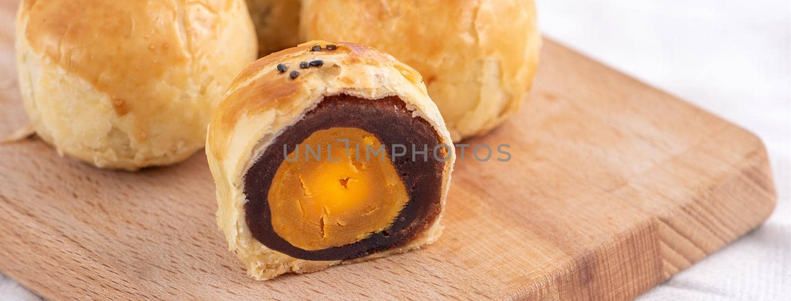 Close up of Moon cake yolk pastry, mooncake for Mid-Autumn Festival holiday on wooden table background