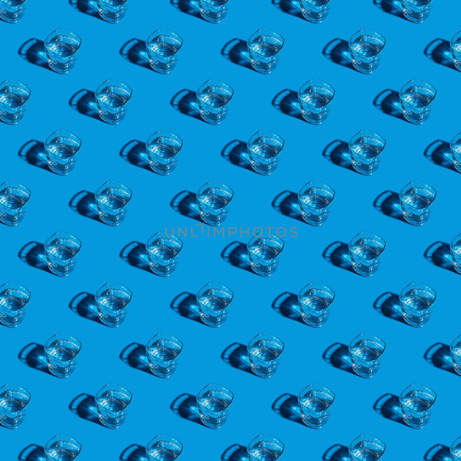 Seamless pattern of glasses with water on a blue background. by Yurich32