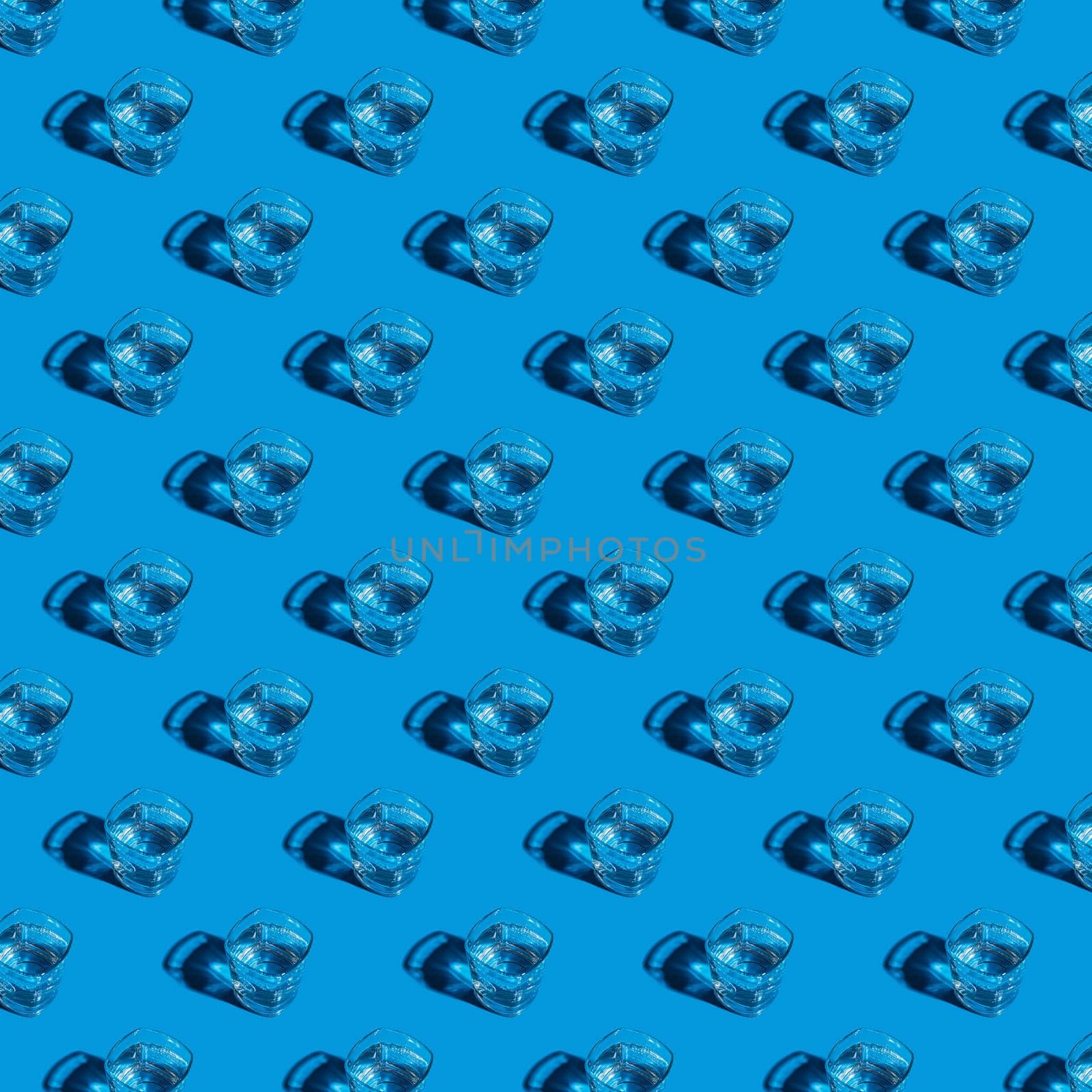 Seamless pattern of glasses with water on a blue background. For printing posters on fabric.