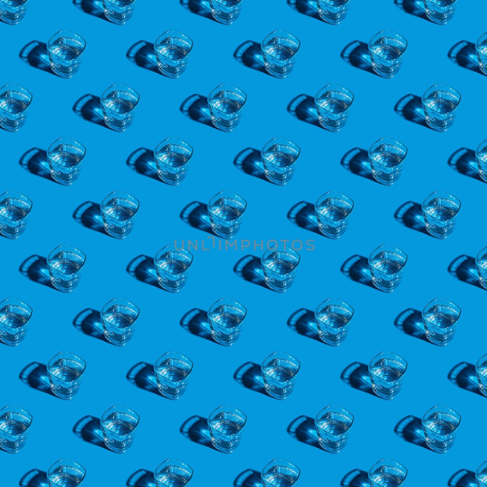 Seamless pattern of glasses with water on a blue background. For printing posters on fabric.