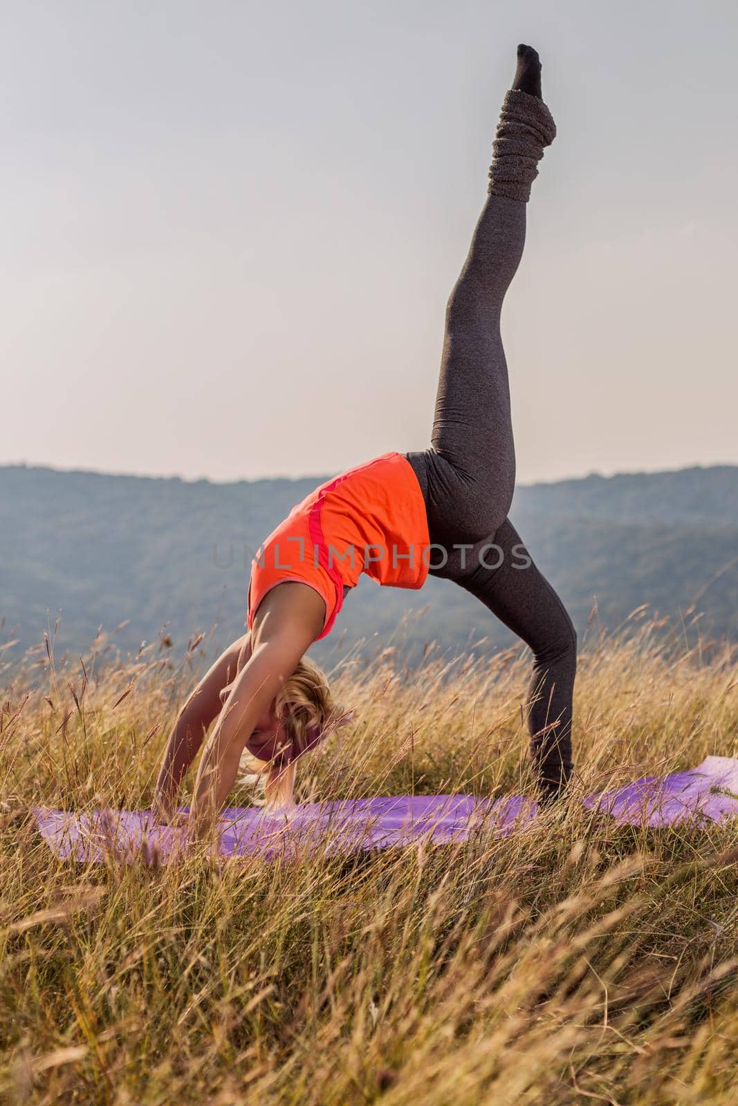 Beautiful woman doing yoga in the nature by Bazdar