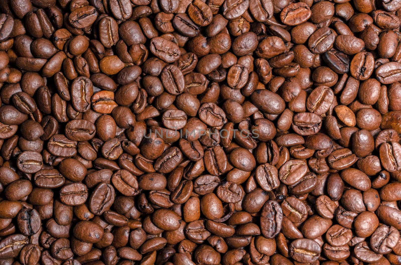 Fresh brown roasted coffee beans as a background by Estival