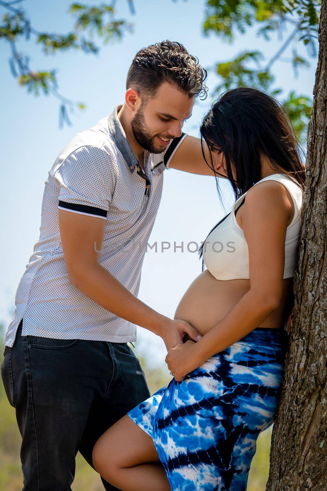Photo of a young pregnant woman and a young man looking at each other