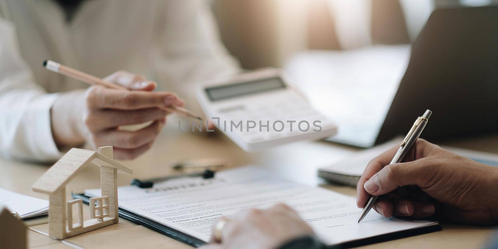 state agent gives pen and documents agreement with customer to sign contract. by wichayada