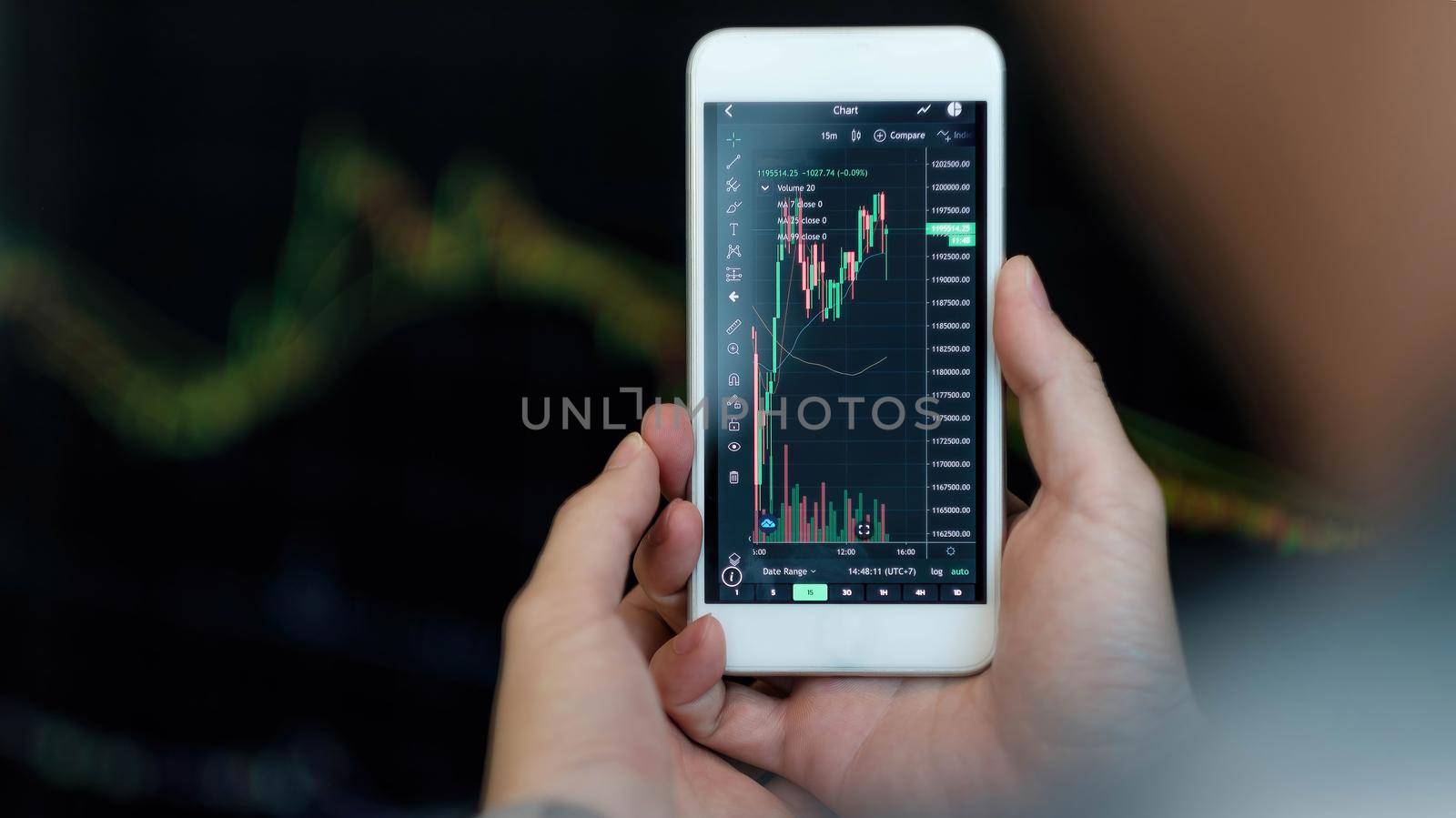 Business man trader investor analyst using mobile phone app analytics for cryptocurrency financial market analysis, trading data index chart graph on smartphone.