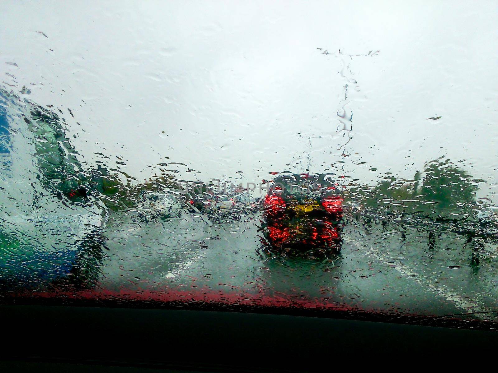 Driving with heavy rain on car windscreen and poor visibility.