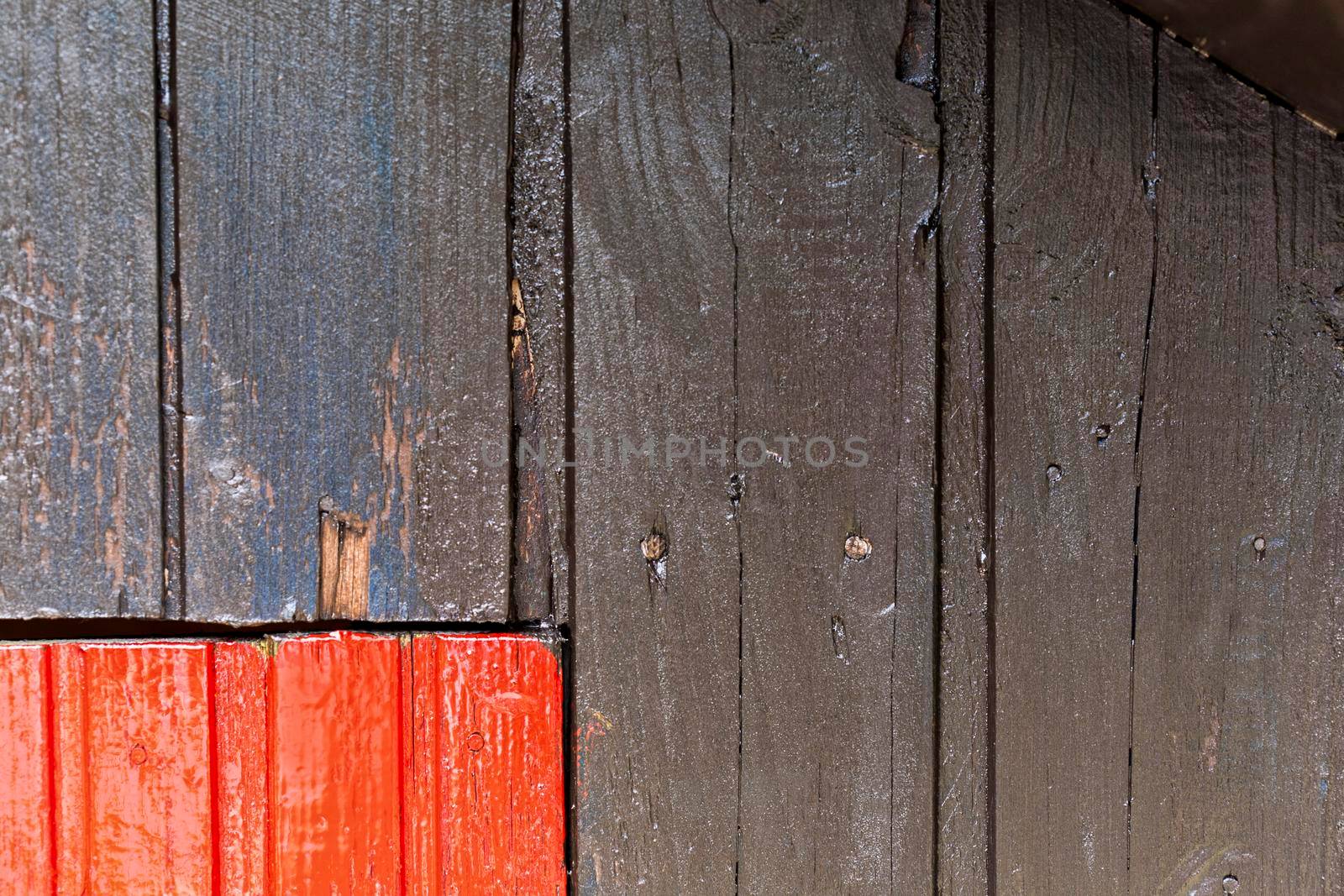 Red and black wooden wall with diferent color pattern.