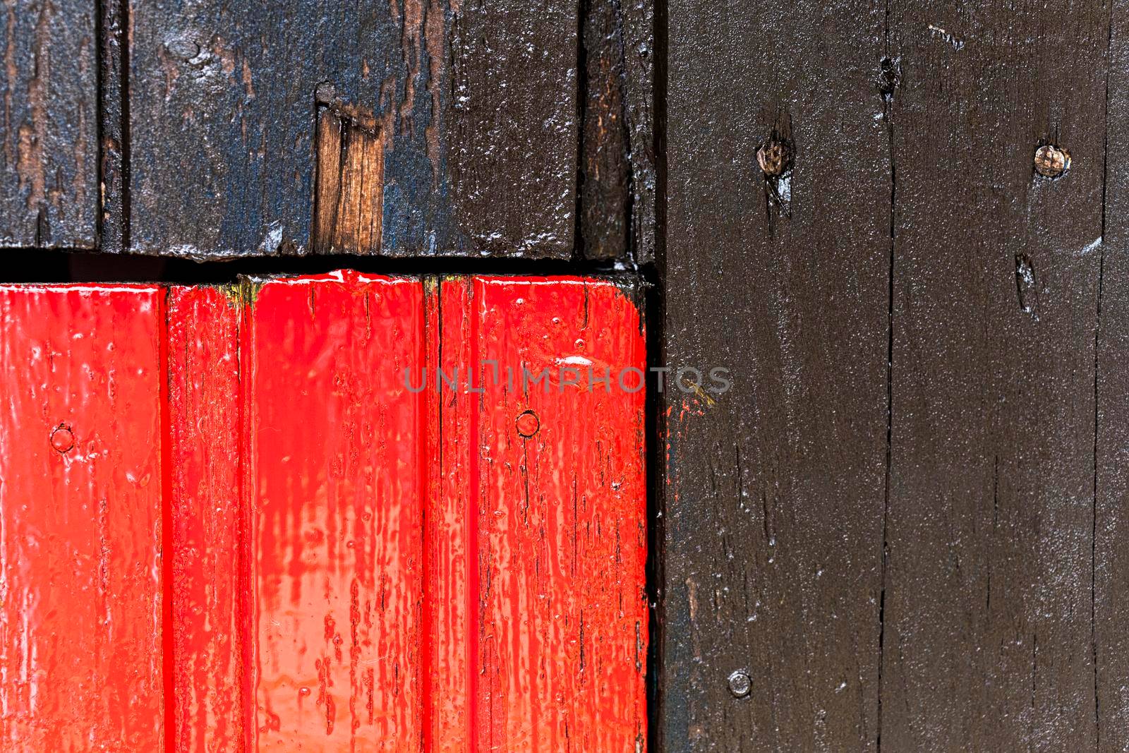 Red and black wooden wall with diferent color pattern.