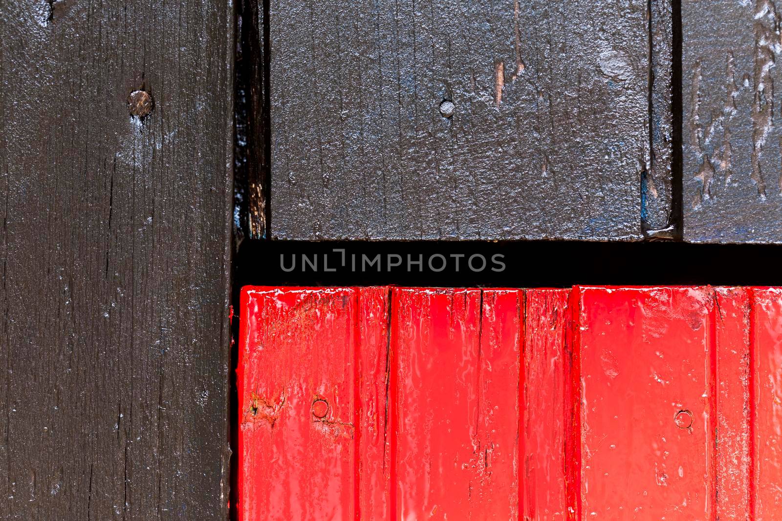 Red and black wooden wall with diferent color pattern.