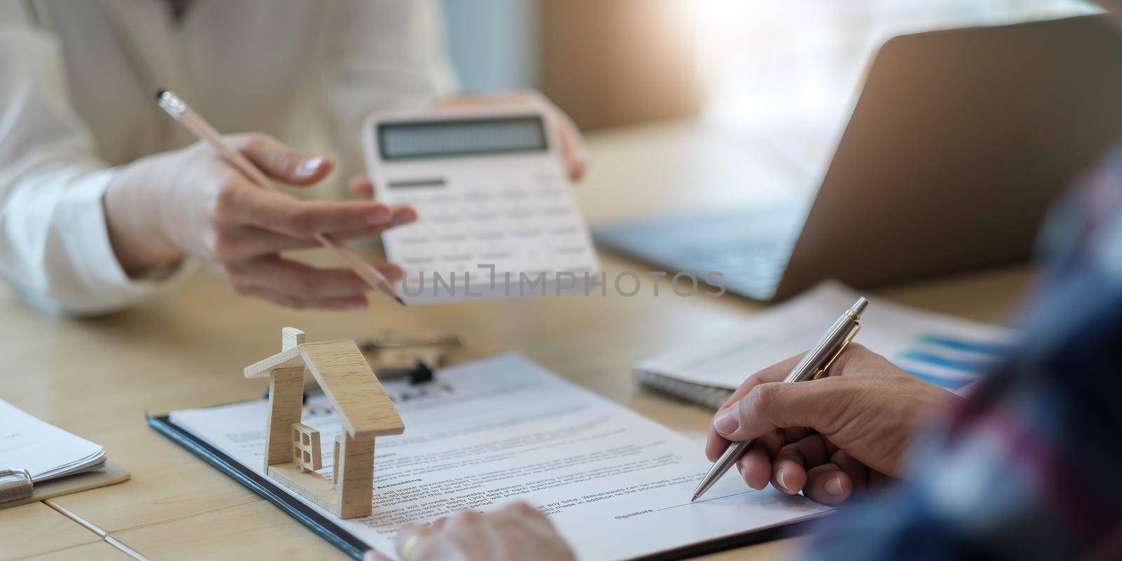 Business people signing a contract to buy or sell real estate..