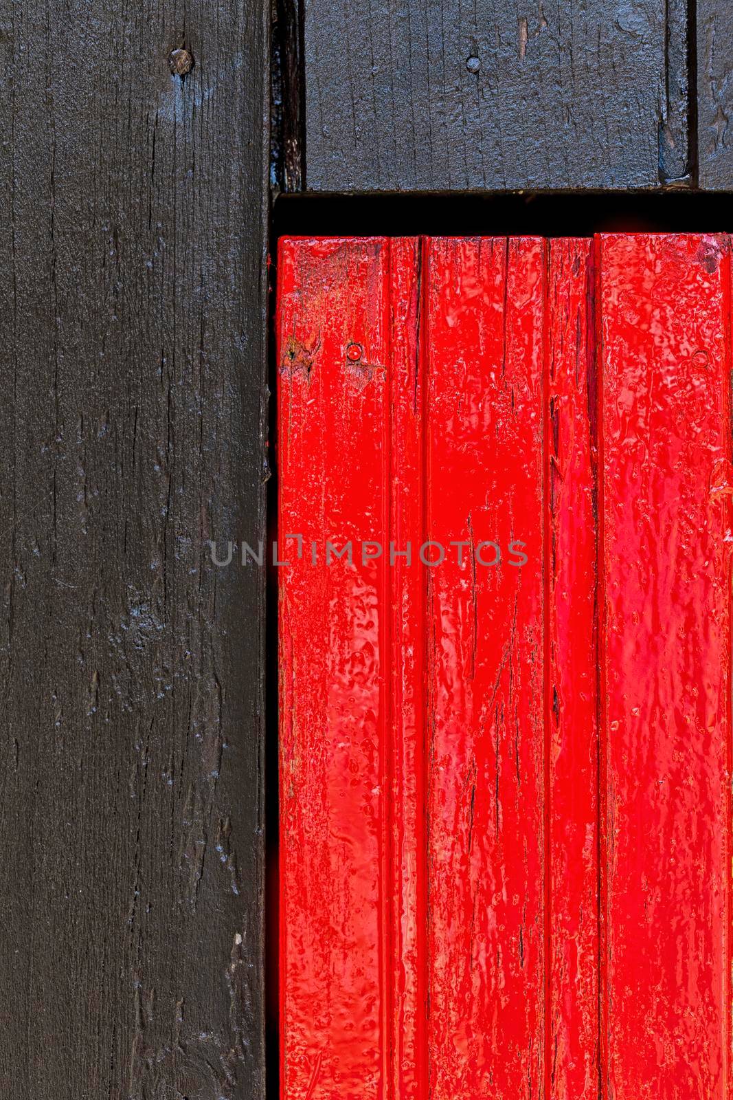 Red and black wooden wall with diferent color pattern.