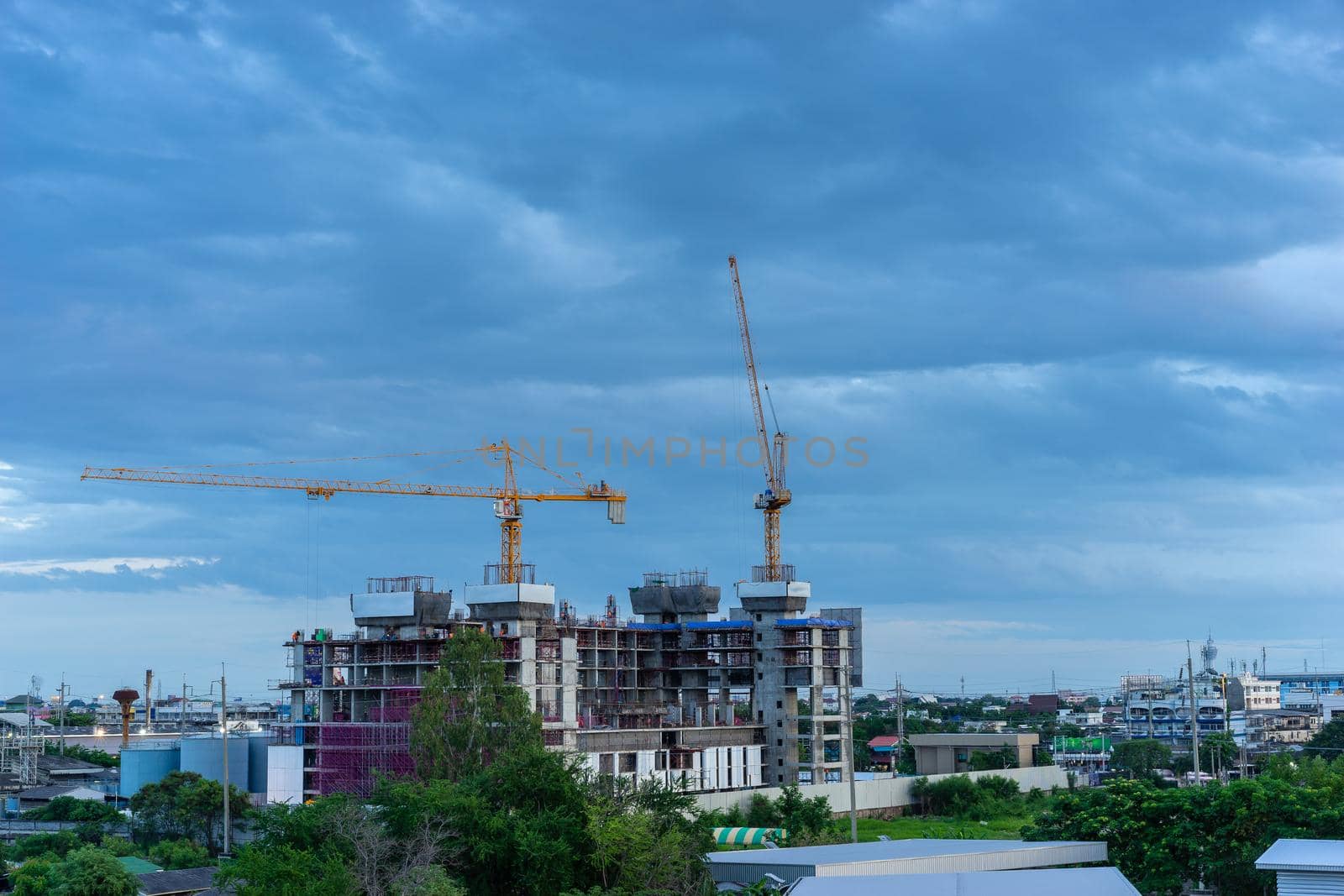 Construction site with cranes in the evening