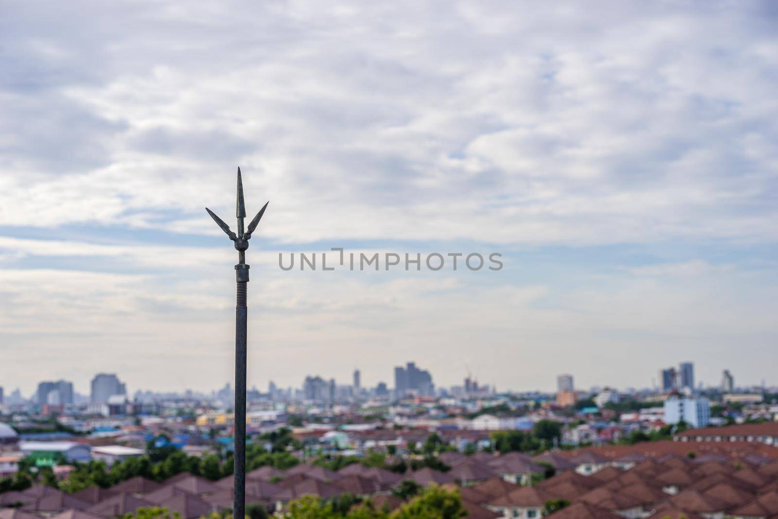 Lightning rod on the rooftop with cityscape background