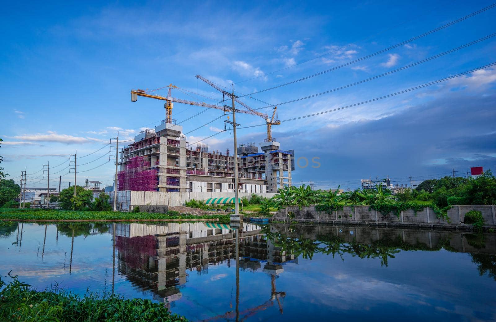 Construction site with cranes and blue sky