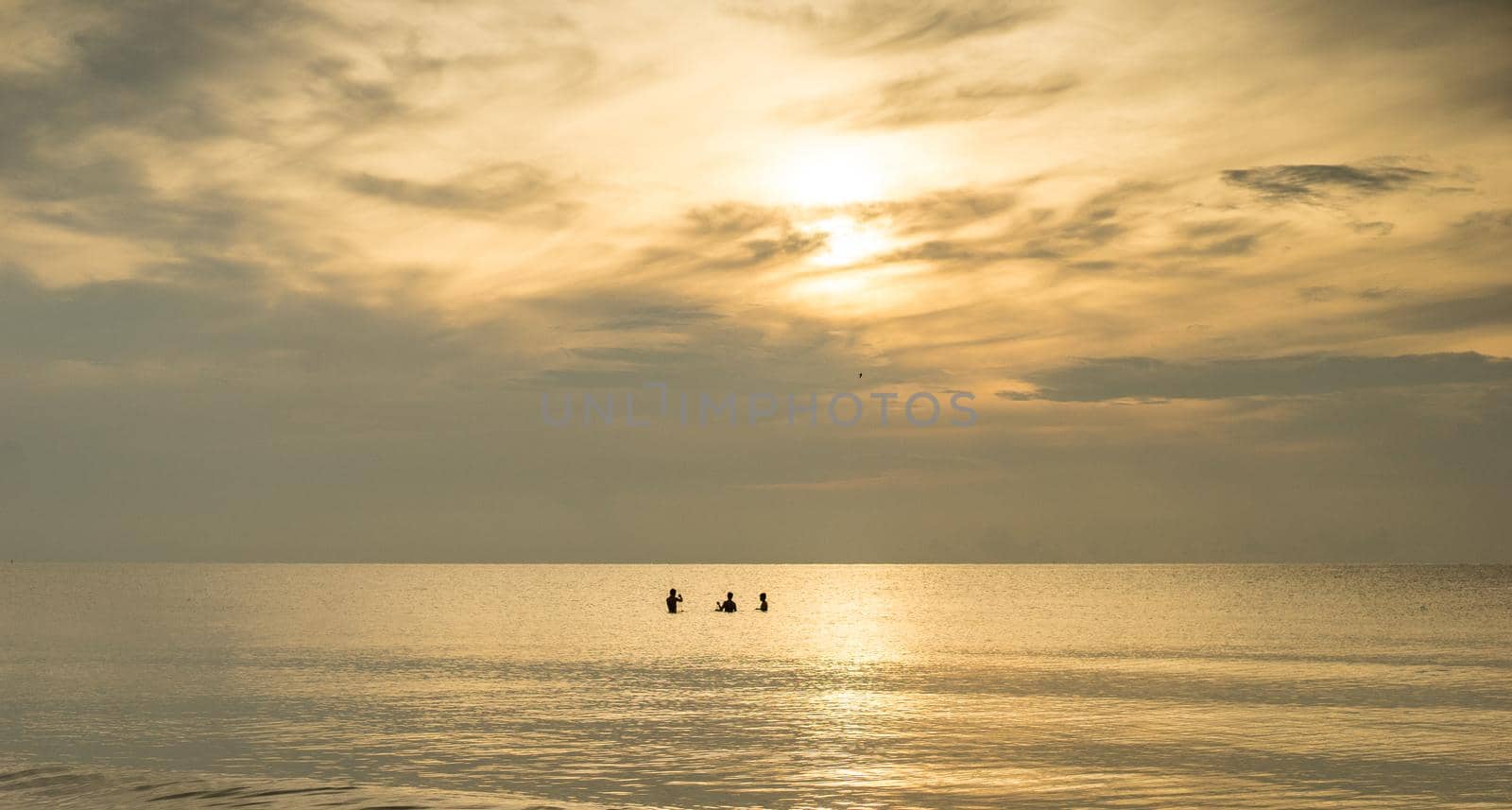 silhouette of fishermans with sunrise in the background by domonite