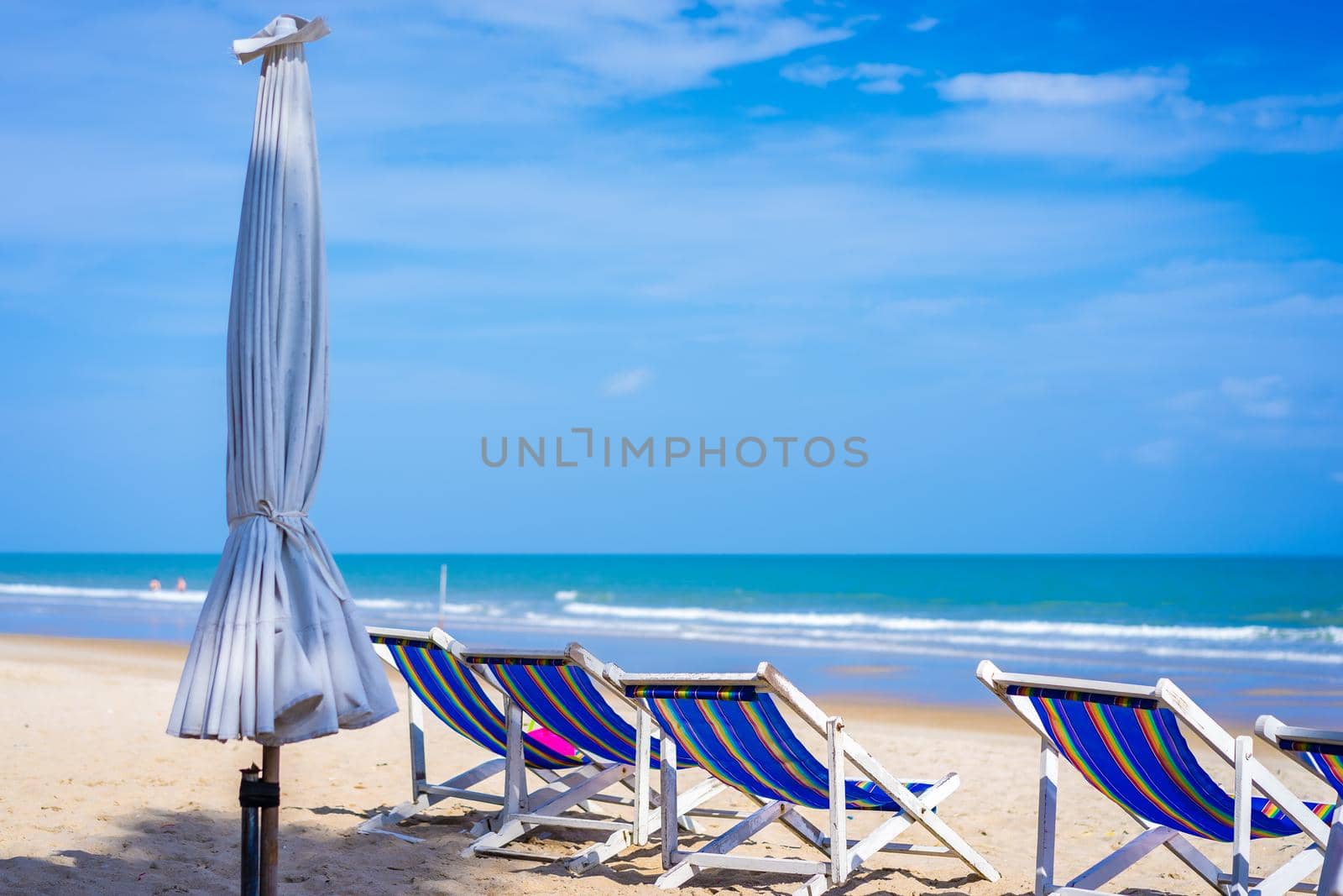 Beach chairs on the white sand beach in summer by domonite