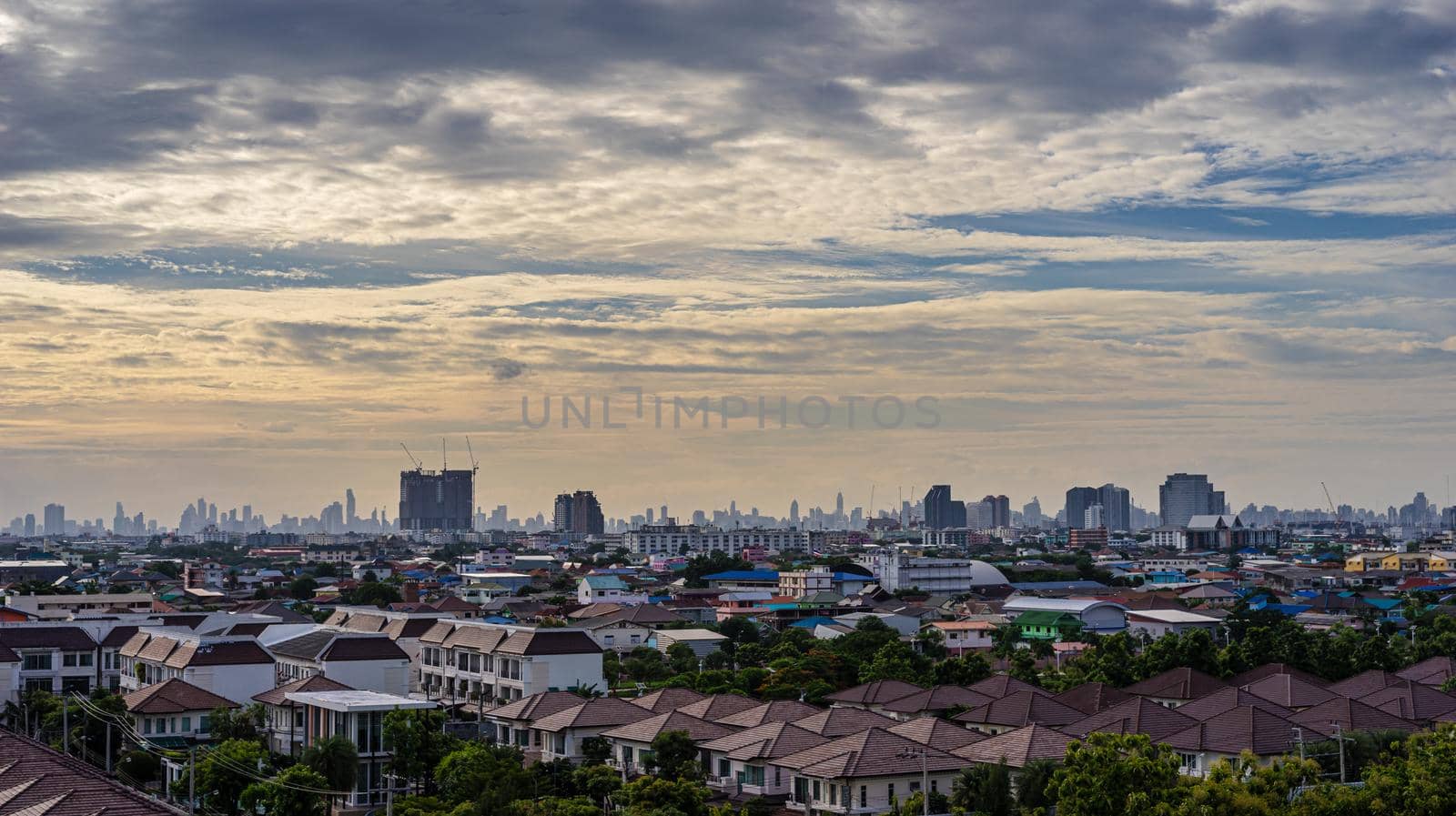 Cityscape of beautiful urban and cloudy sky in the evening by domonite
