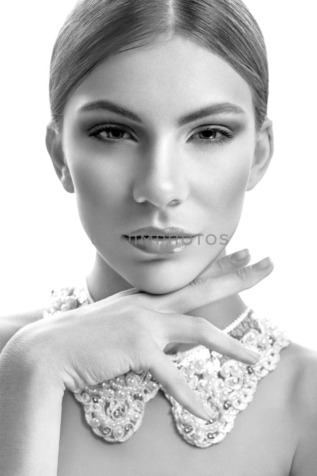 Old fashioned beauty. Monochrome vertical close up portrait of a gorgeous sexy young woman posing confidently with her hand to her chin wearing lacey collar necklace chin fashion style concept