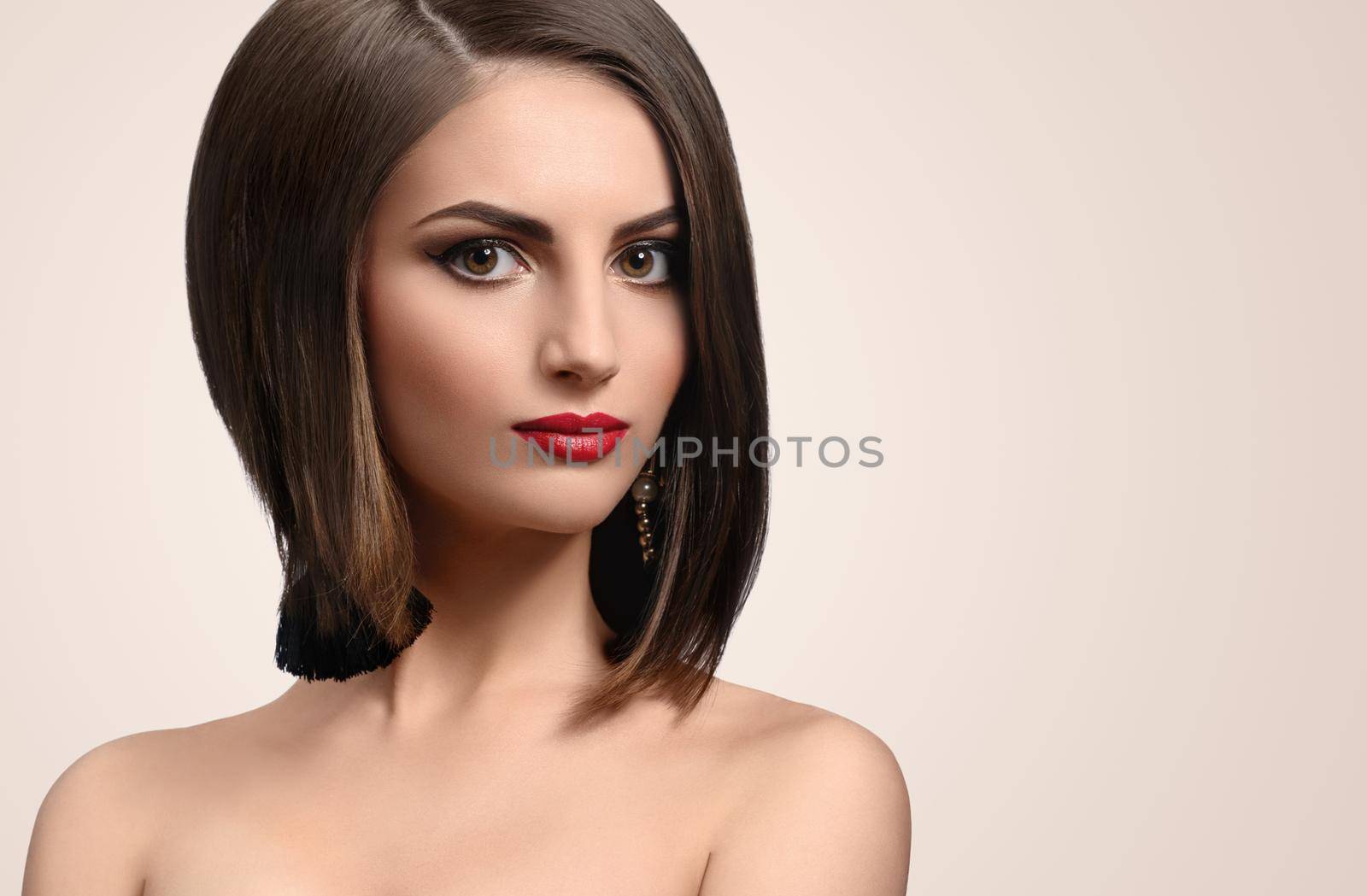 Beautiful elegant young woman posing in studio by SerhiiBobyk