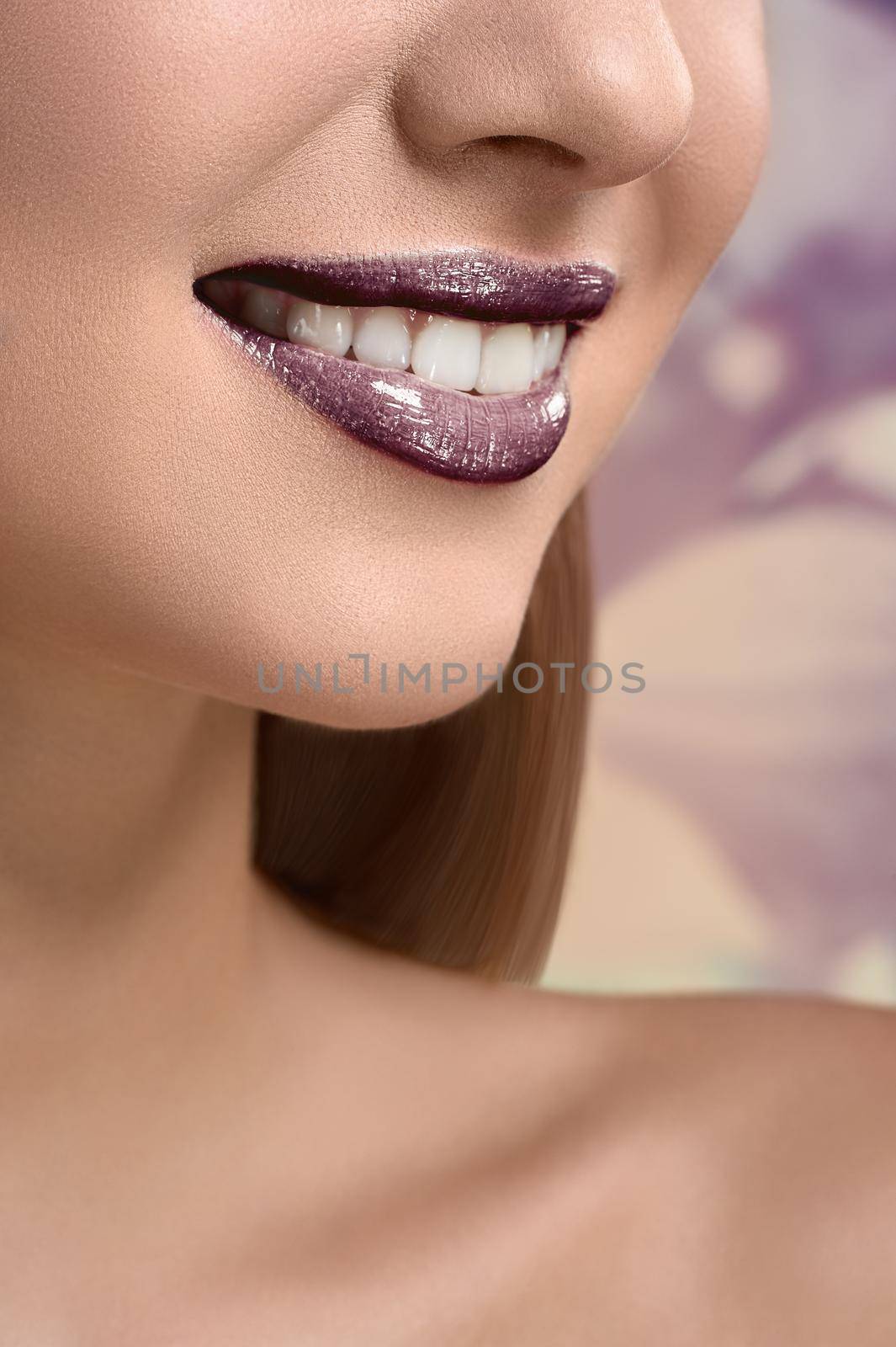 Beautiful glossy lips. Vertical close up of a woman with great healthy white teeth smiling mouth open lips covered in plum lip gloss copyspace beauty cosmetics dentistry whitening bleaching concept