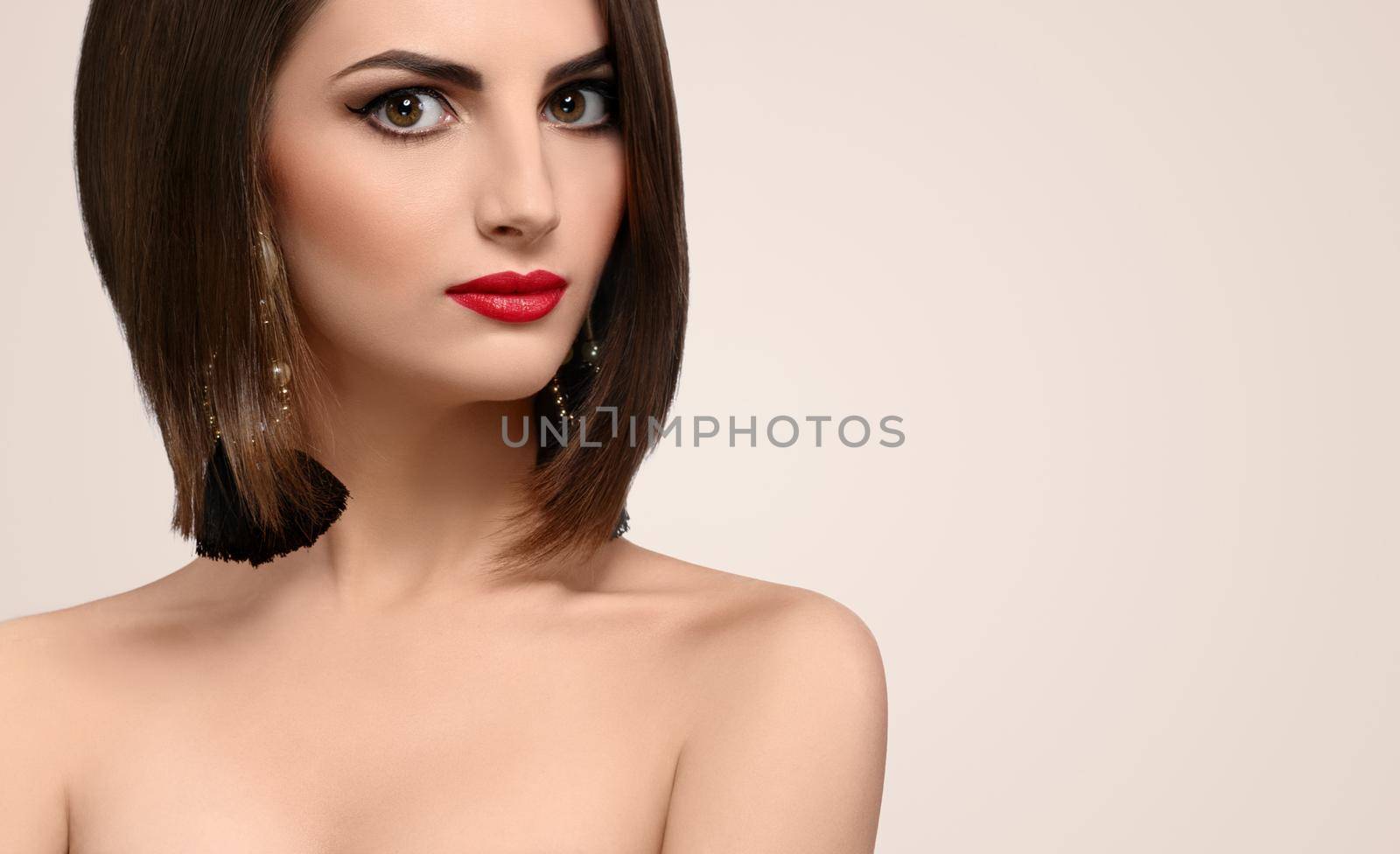 Gorgeous red lipped brunette with healthy shiny hair looking to the camera confidently copyspace elegance beauty cosmetics skincare perfection femininity concept