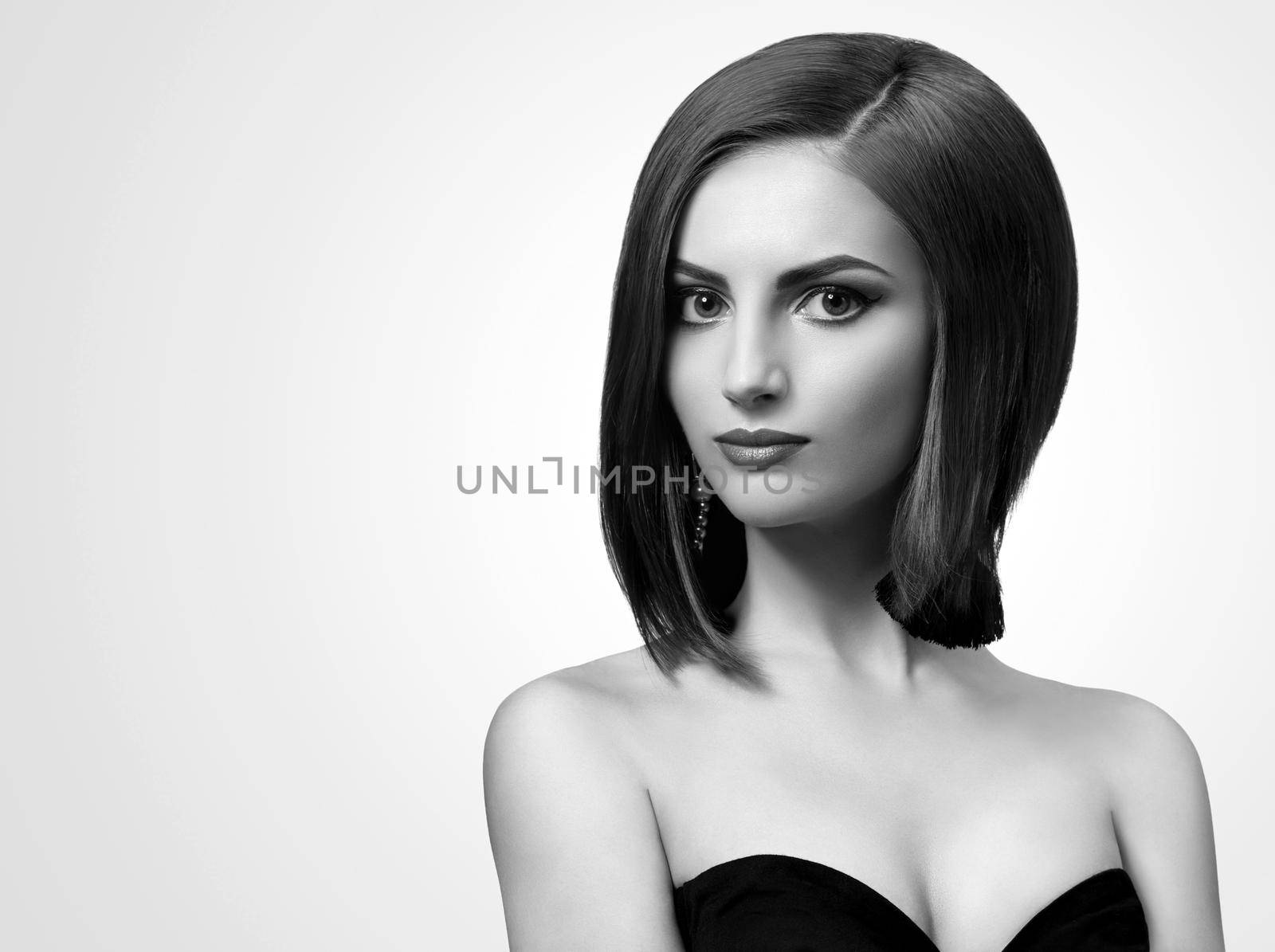 Classy lady. Black and white studio shot of an attractive young classy elegant woman looking to the camera copyspace confident graceful elegant glamorous beauty style concept