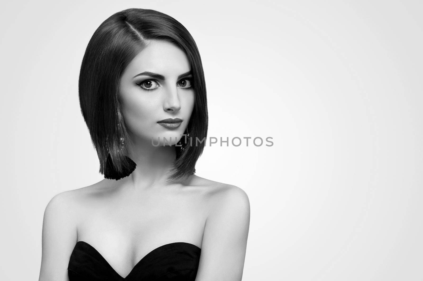 Captivating beauty. Black and white portrait of a beautiful confident young woman looking to the camera posing sensually at studio copyspace fashion style lifestyle modeling luxury