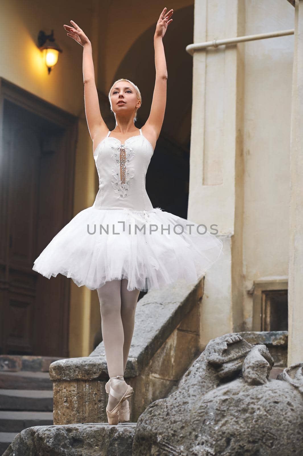 Beautiful ballerina dancing near an old building by SerhiiBobyk