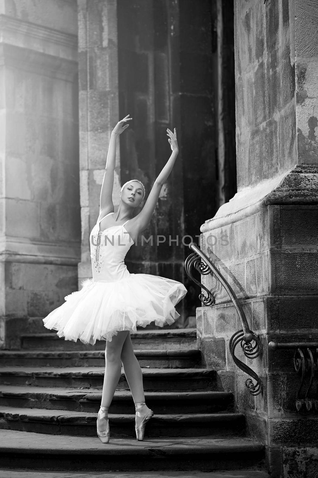 Balance is crucial. Monochrome soft focus shot of a young ballerina performing on the stairs of an old house