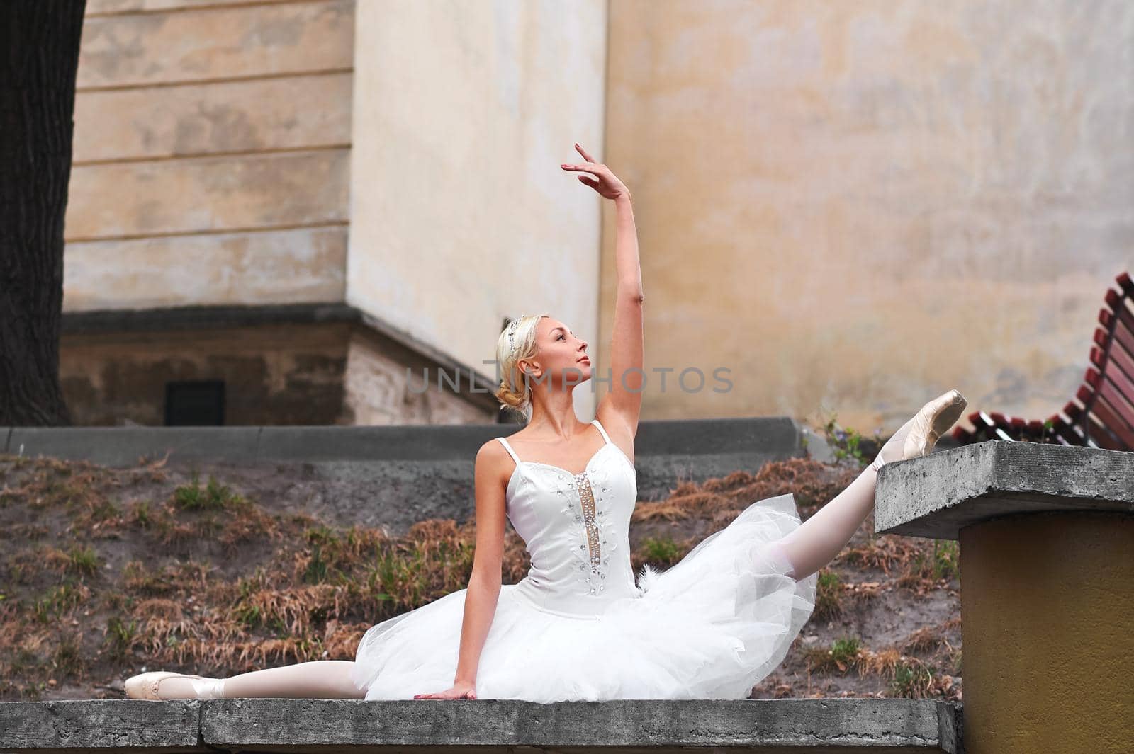 Beautiful graceful ballerina dancing on the streets of an old ci by SerhiiBobyk