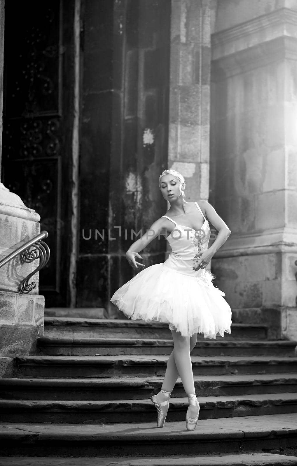 Young ballerina woman posing on stairs by SerhiiBobyk