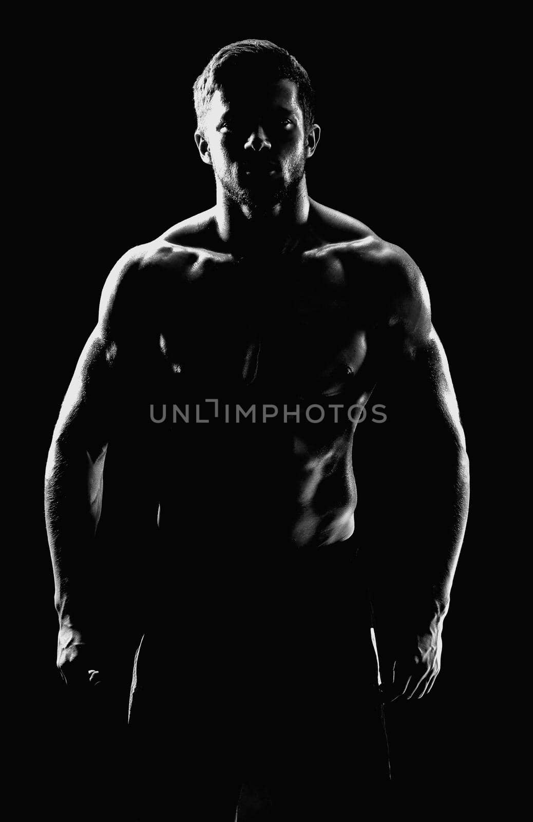 Young muscular fit sportsman posing shirtless on black backgroun by SerhiiBobyk