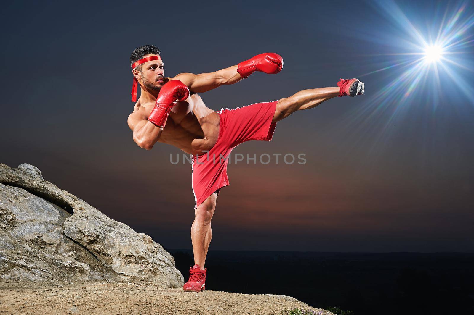 Muscular male boxer training outdoors by SerhiiBobyk