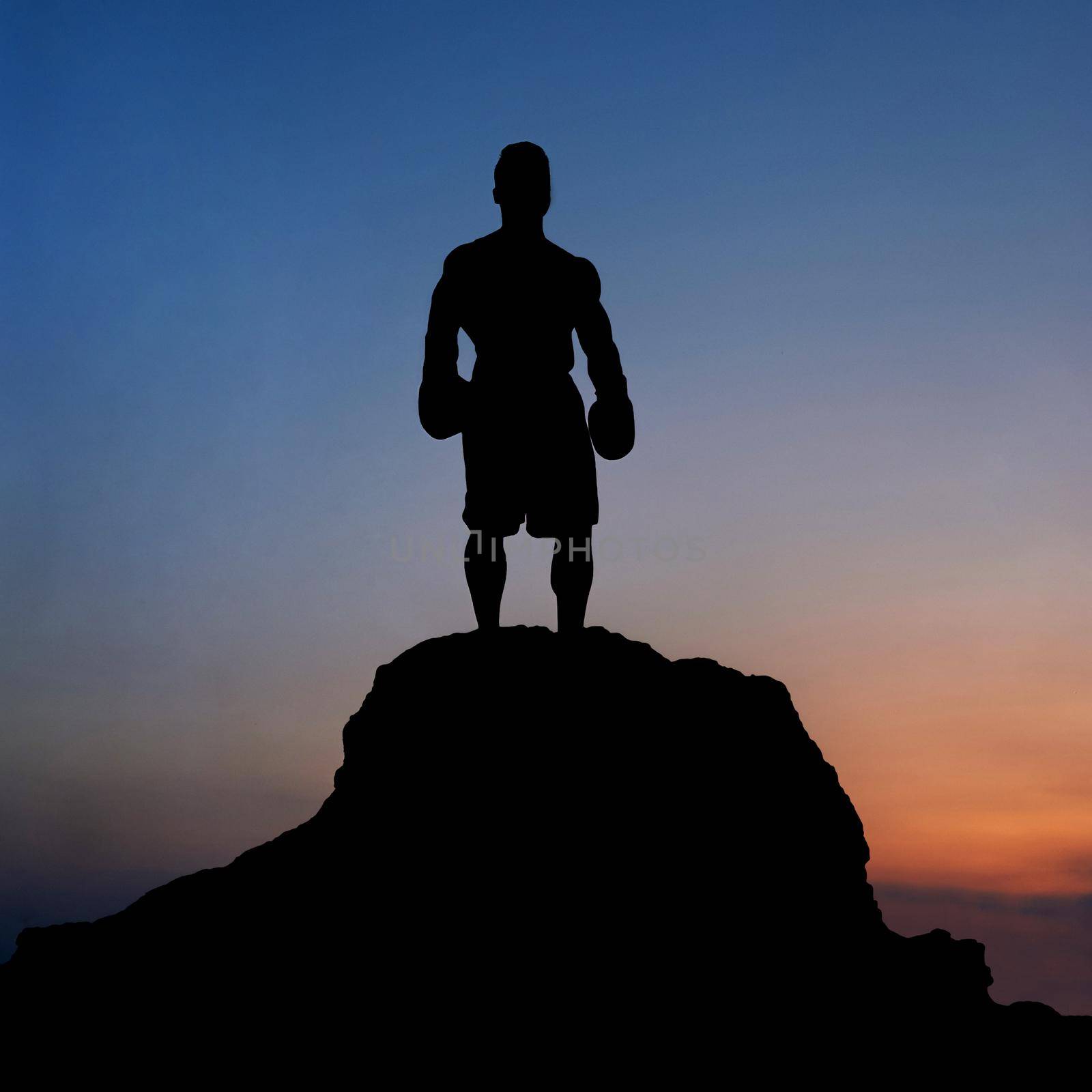 Dark silhouette of a muscular male boxer outdoors on sunset by SerhiiBobyk