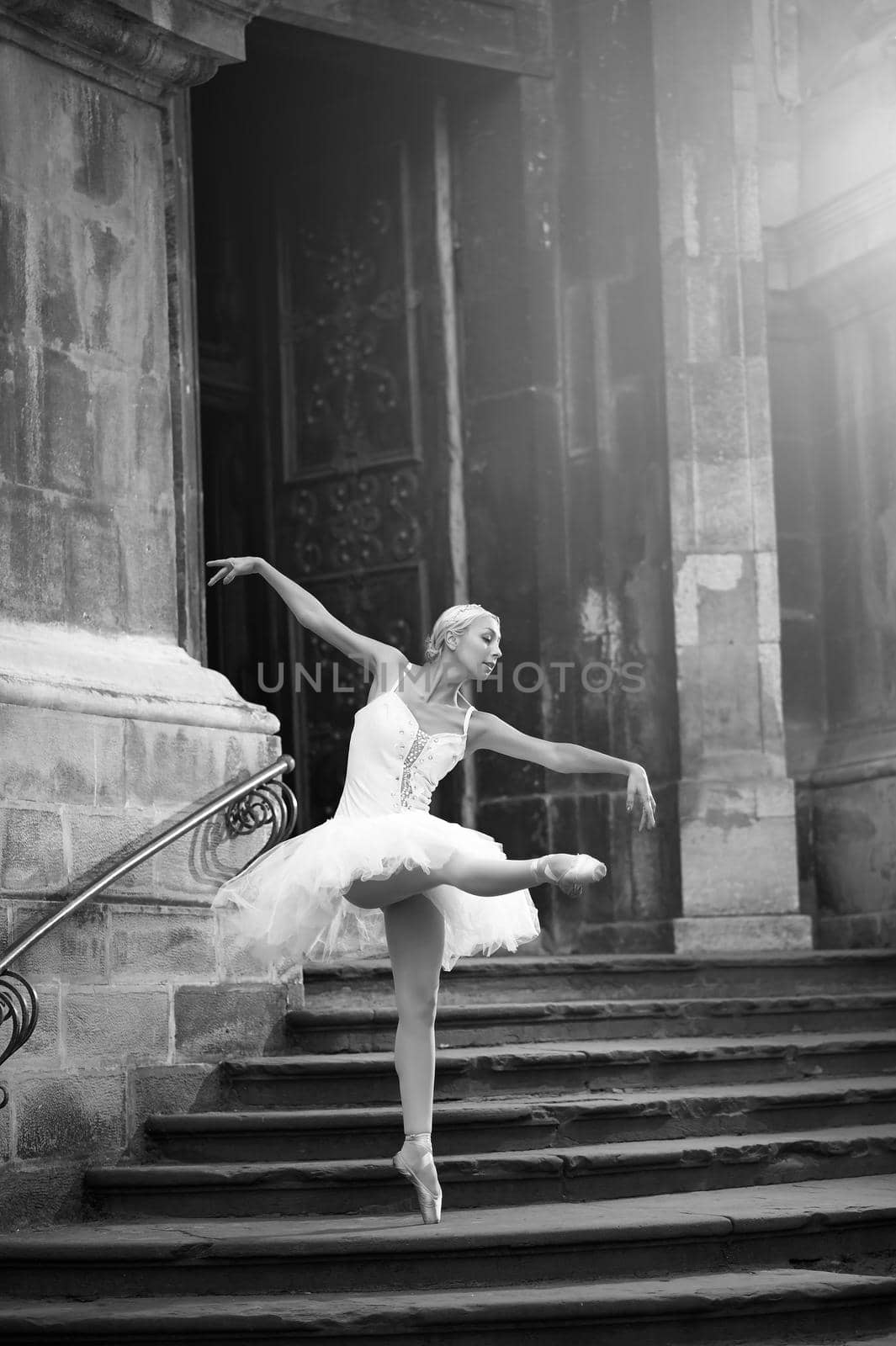 Young ballerina woman posing on stairs by SerhiiBobyk