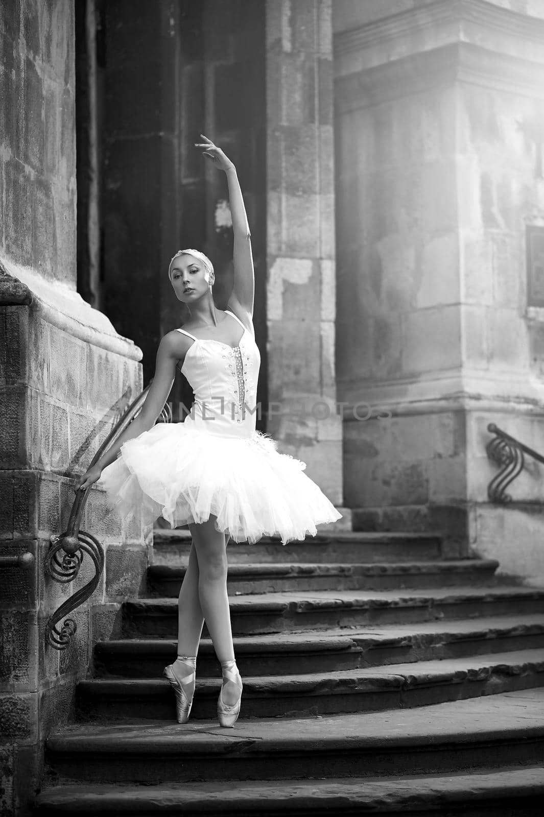 Perfect pose. Monochrome portrait of a stunning young ballet dancer posing outdoors near an old castle soft focus