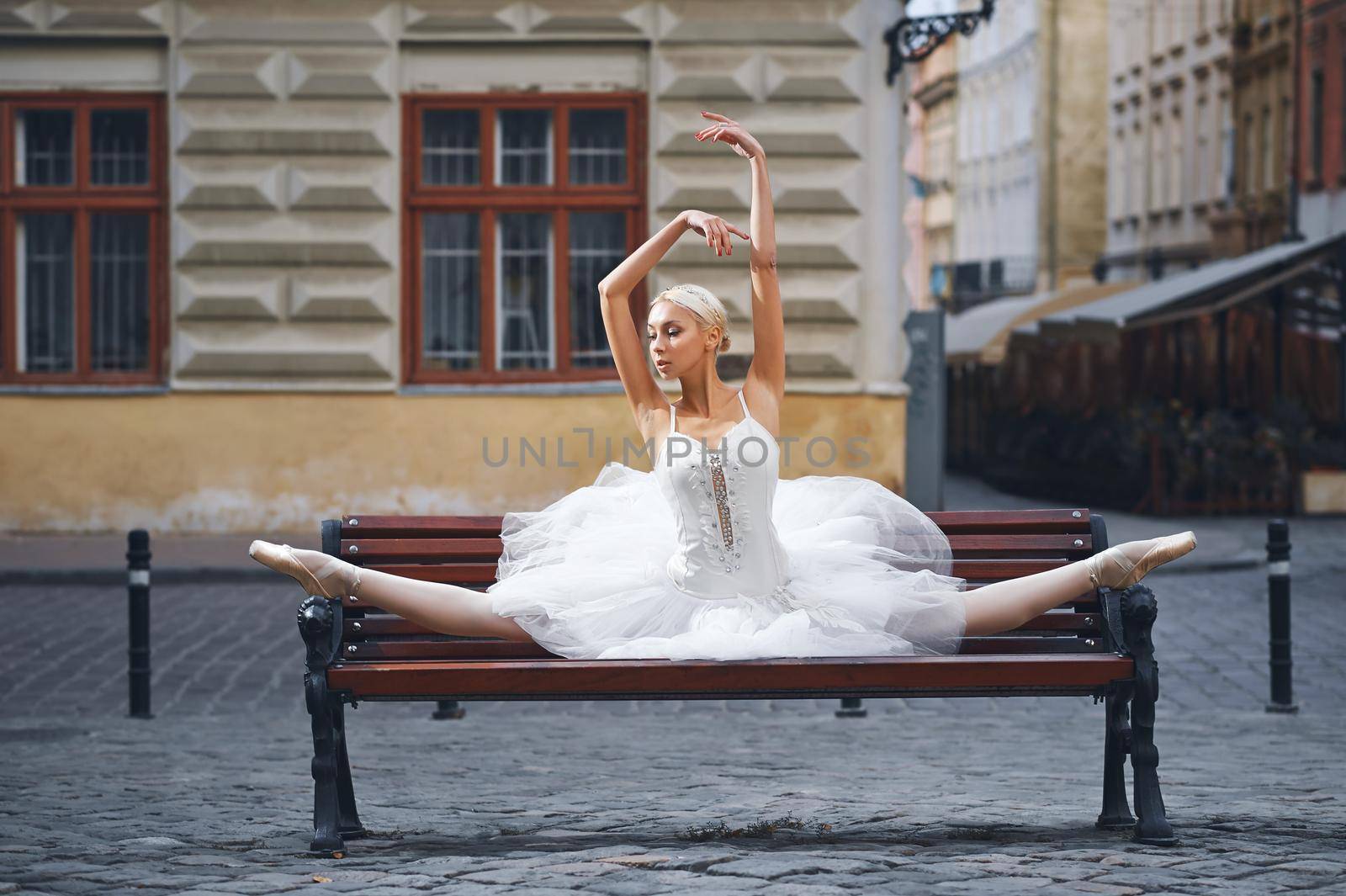 Attractive ballerina sitting on the bench in the city by SerhiiBobyk