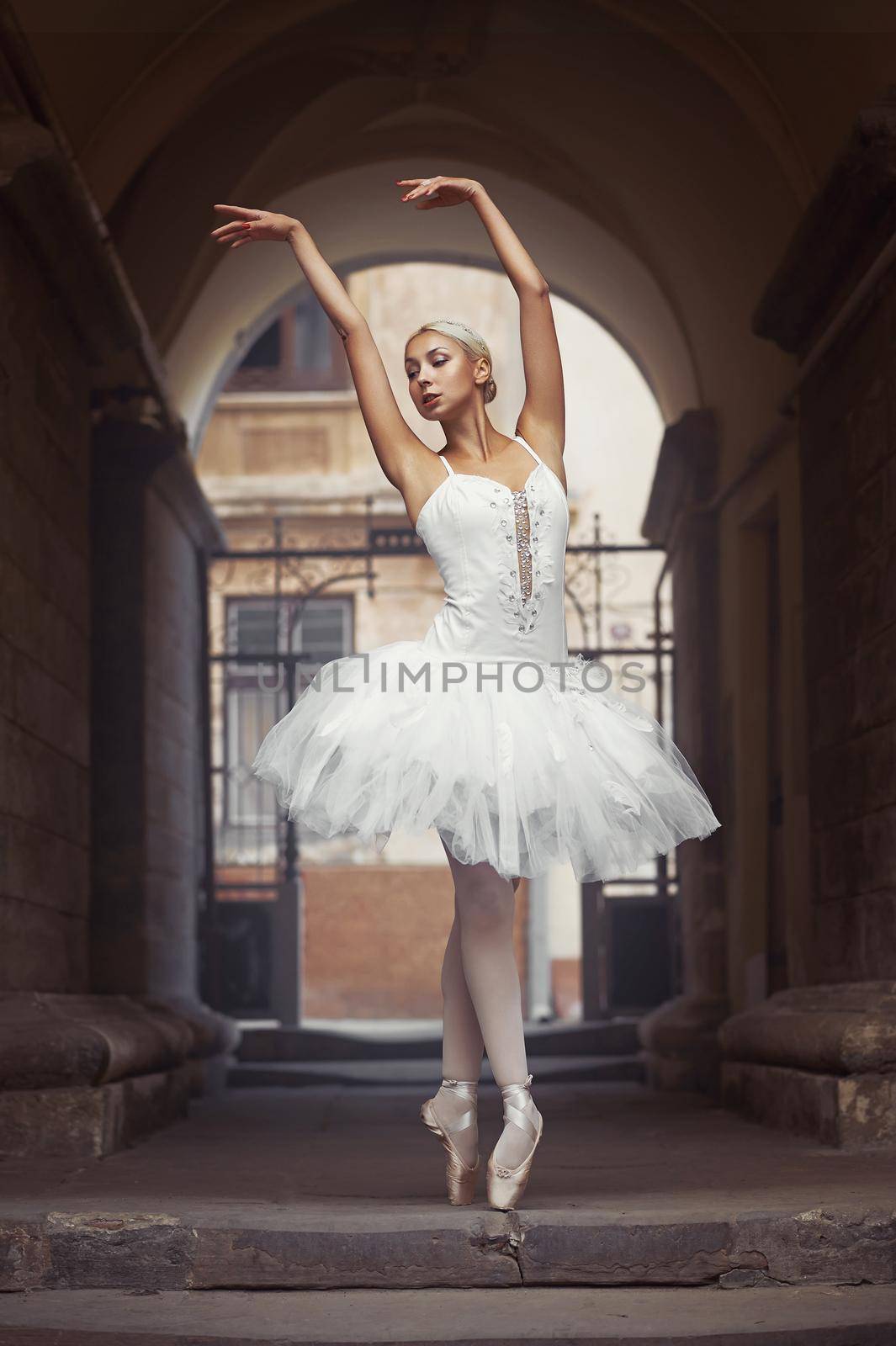 Working on her posture. Young ballerina performing on the streets of her city